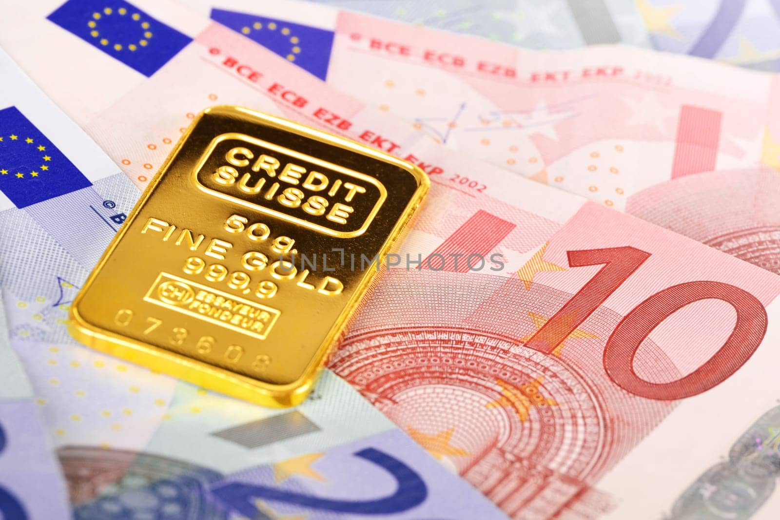 Composition with euro banknotes and swiss gold bar