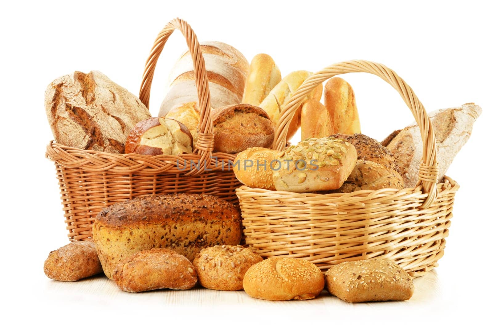Composition with bread and rolls in wicker basket isolated on white