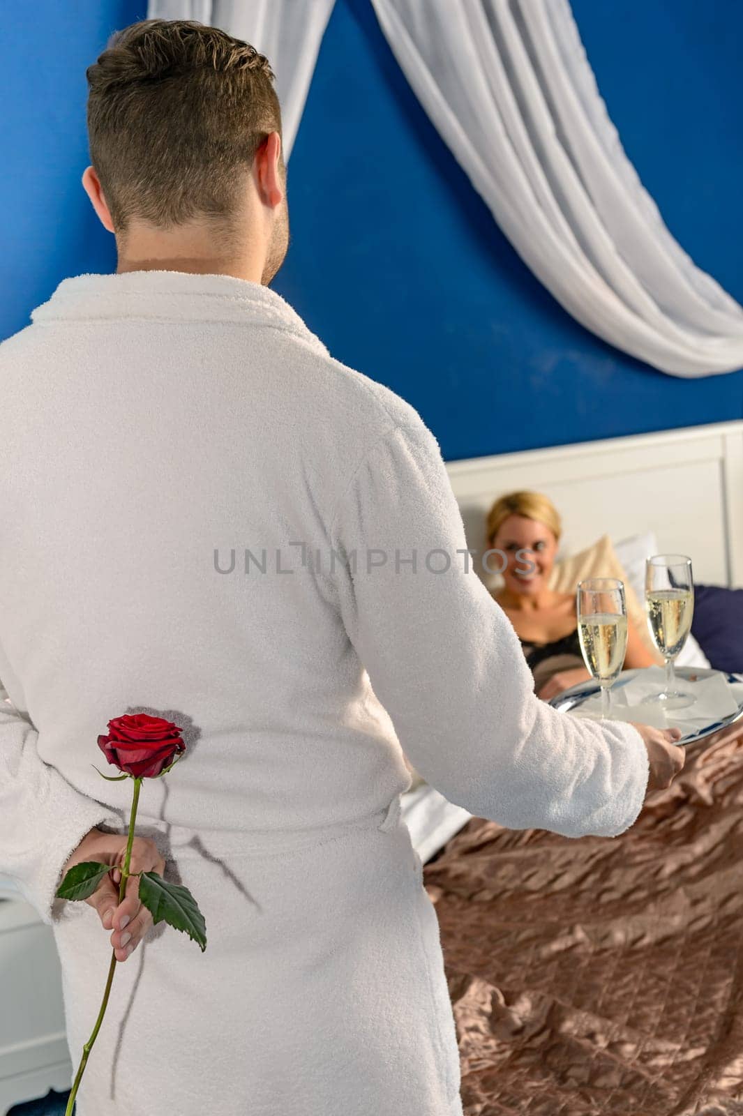 Man passionate flirting affair mistress rose champagne bedroom