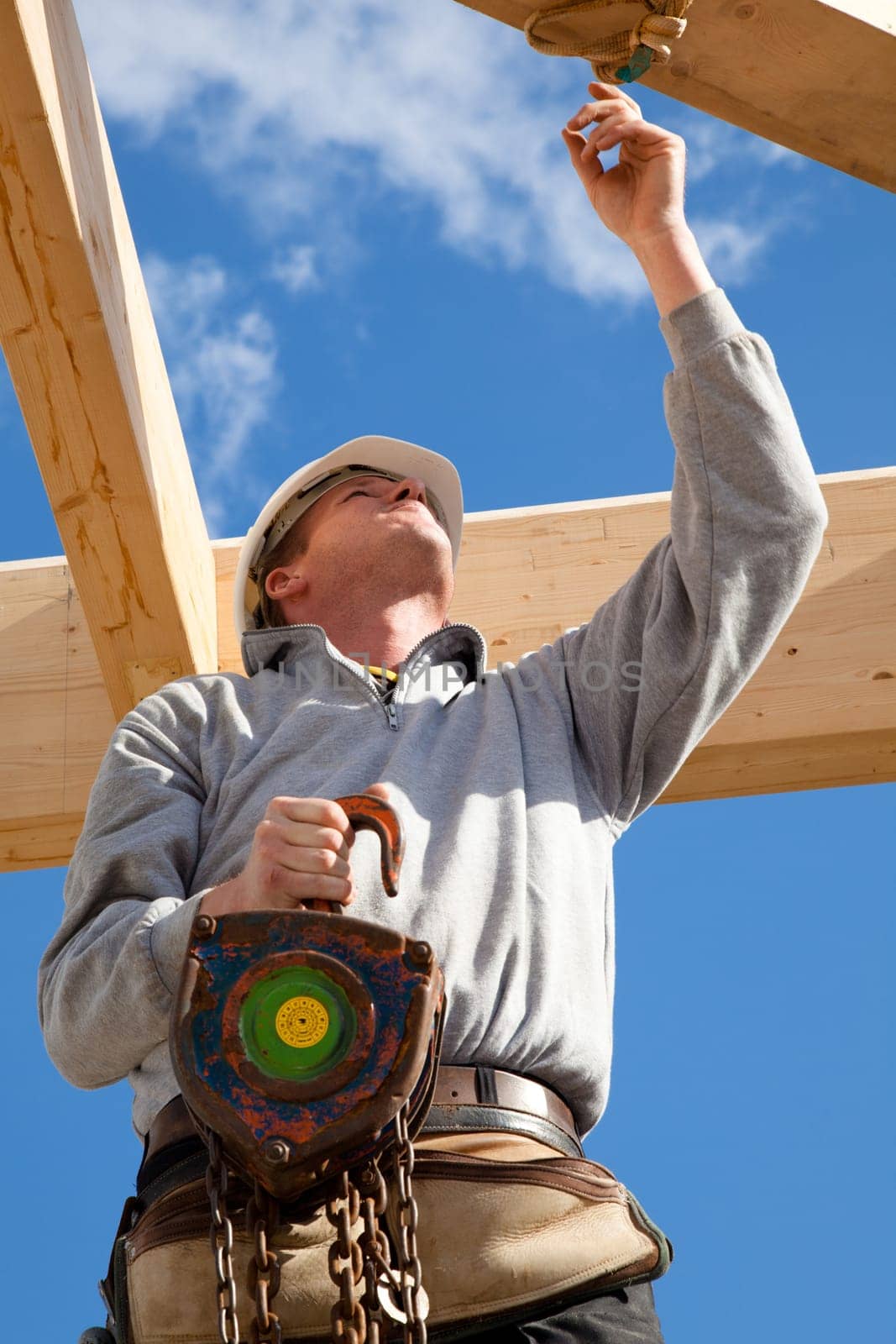 construction worker  at work with wooden  roof construction