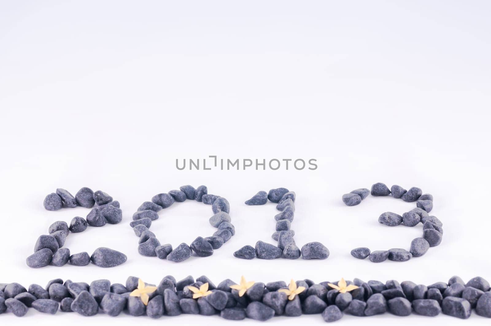 Year 2013 in zen stone with yellow ixora flowers
