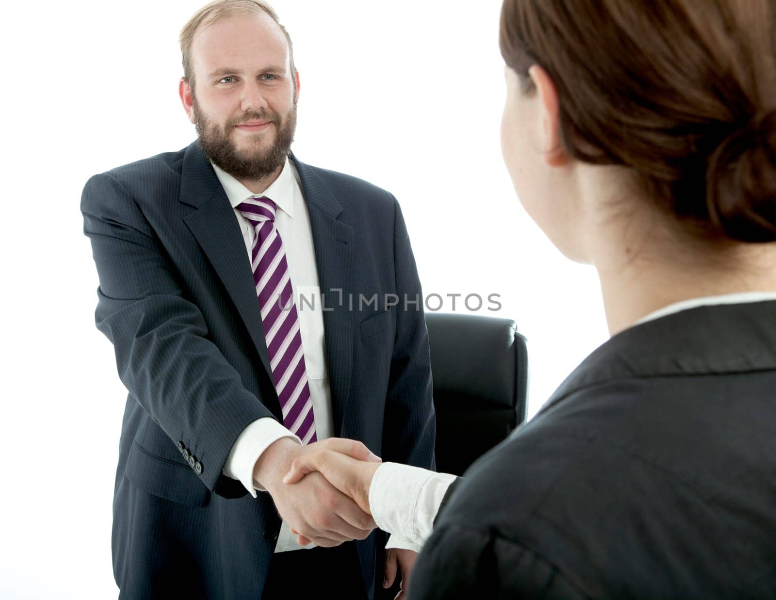 beard business man brunette woman desk handshake