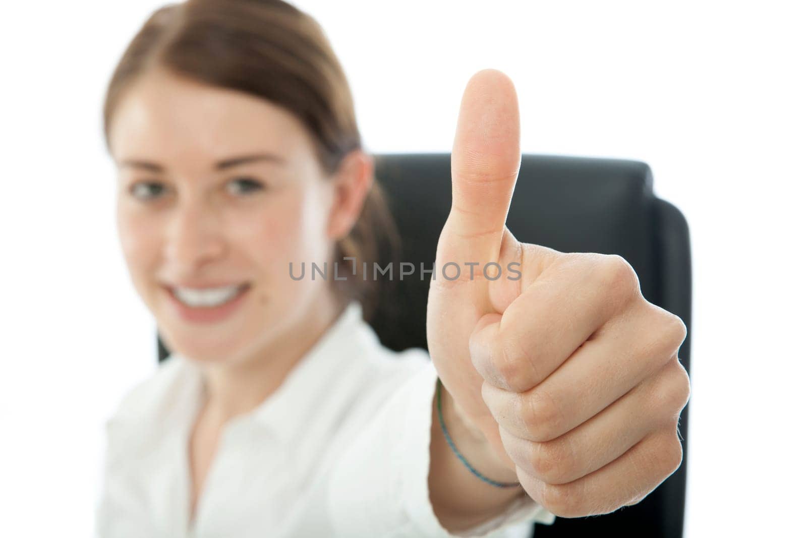 young brunette business woman thumb up and smiles