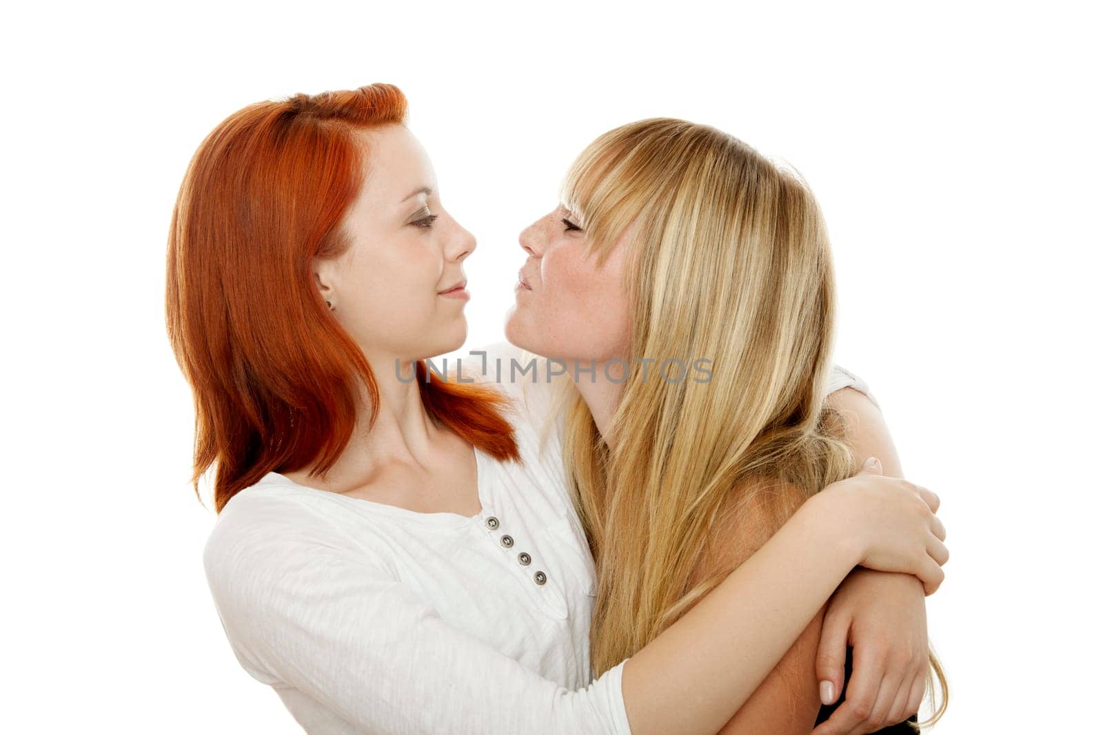 young beautiful red and blond haired girls in front of white background