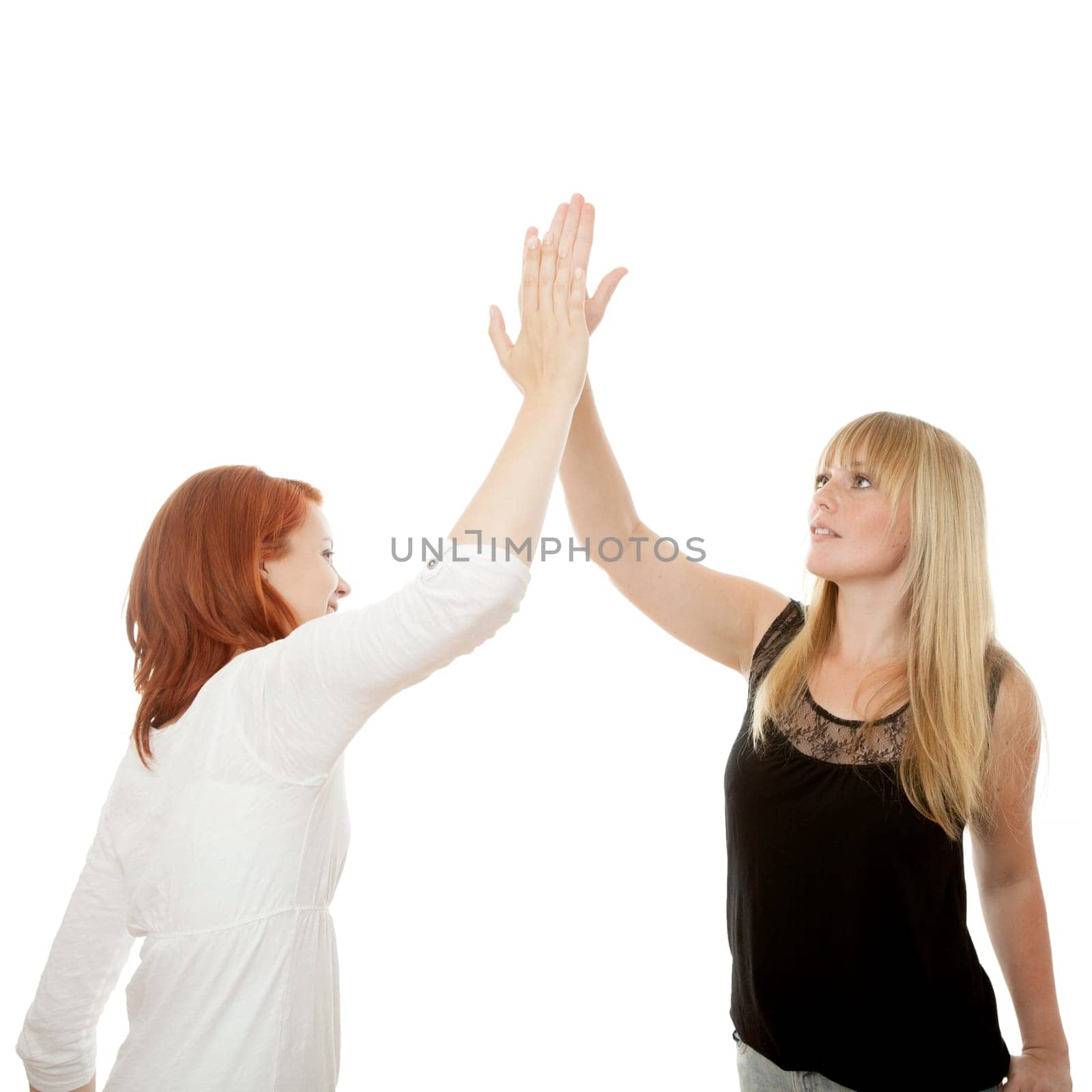 young beautiful red and blond haired girls in front of white background