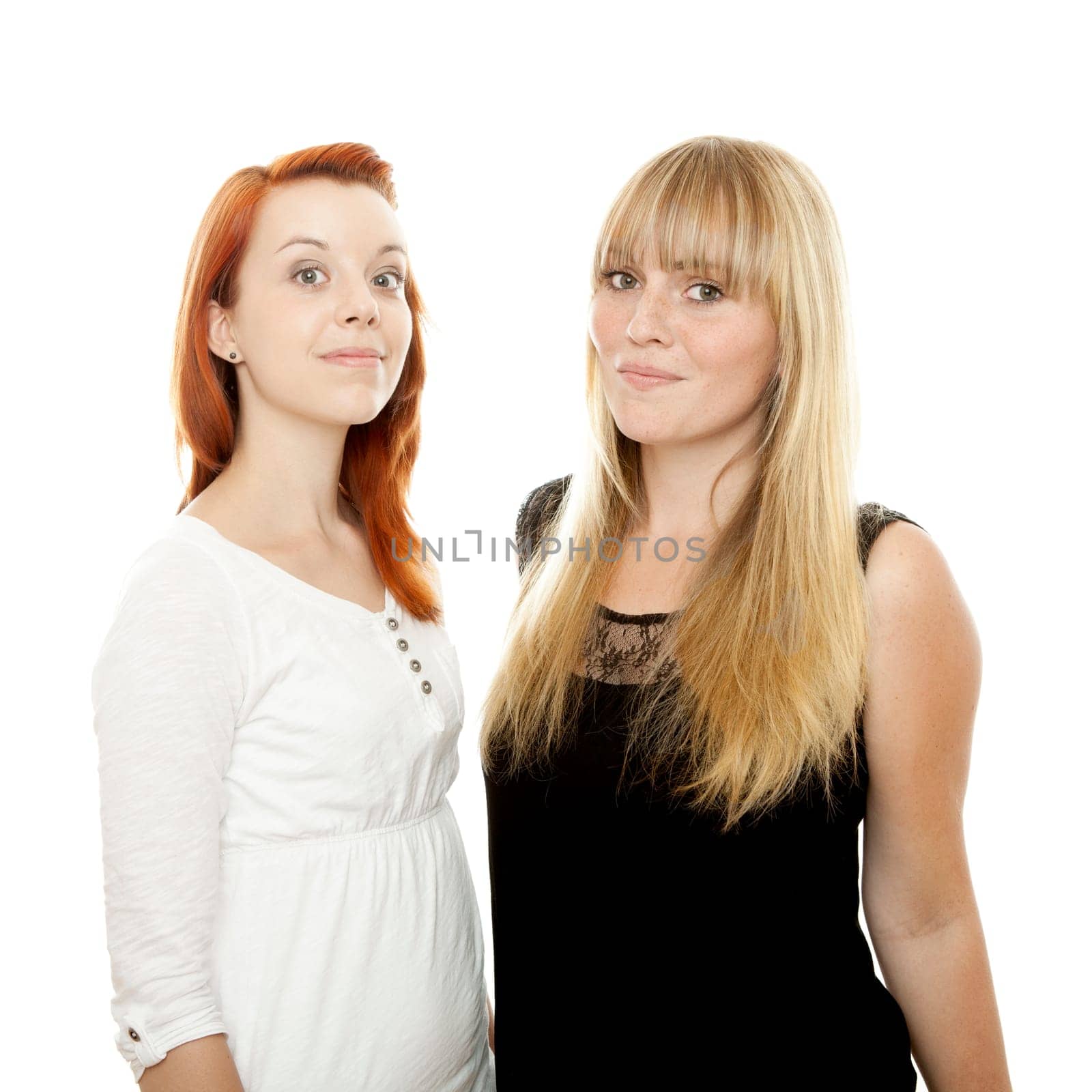 young beautiful red and blond haired girls in front of white background
