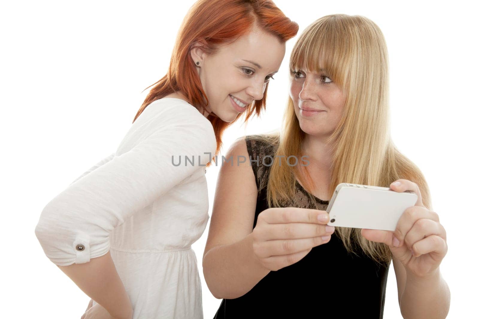 young beautiful red and blond haired girls in front of white background