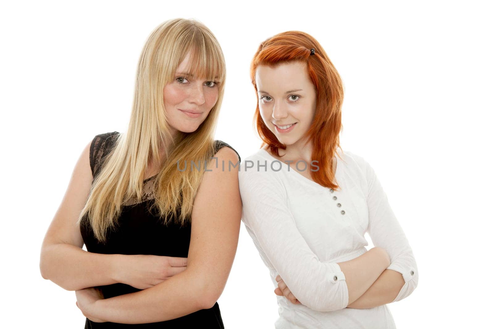 young beautiful red and blond haired girls in front of white background