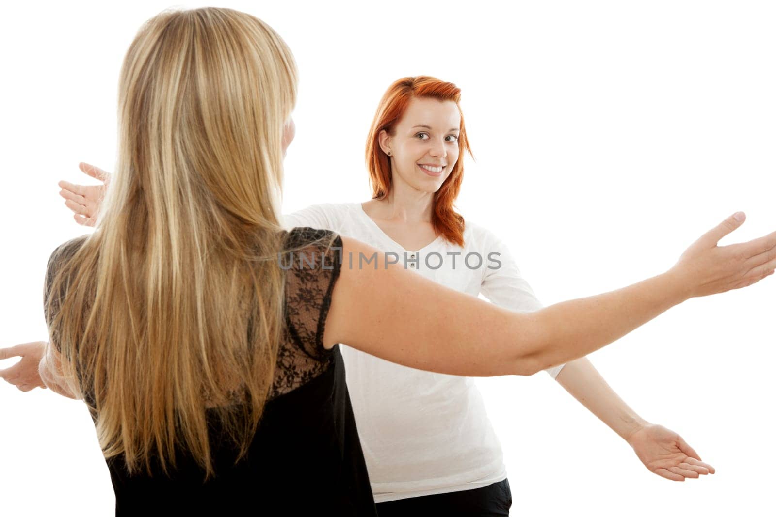 young beautiful red and blond haired girls in front of white background