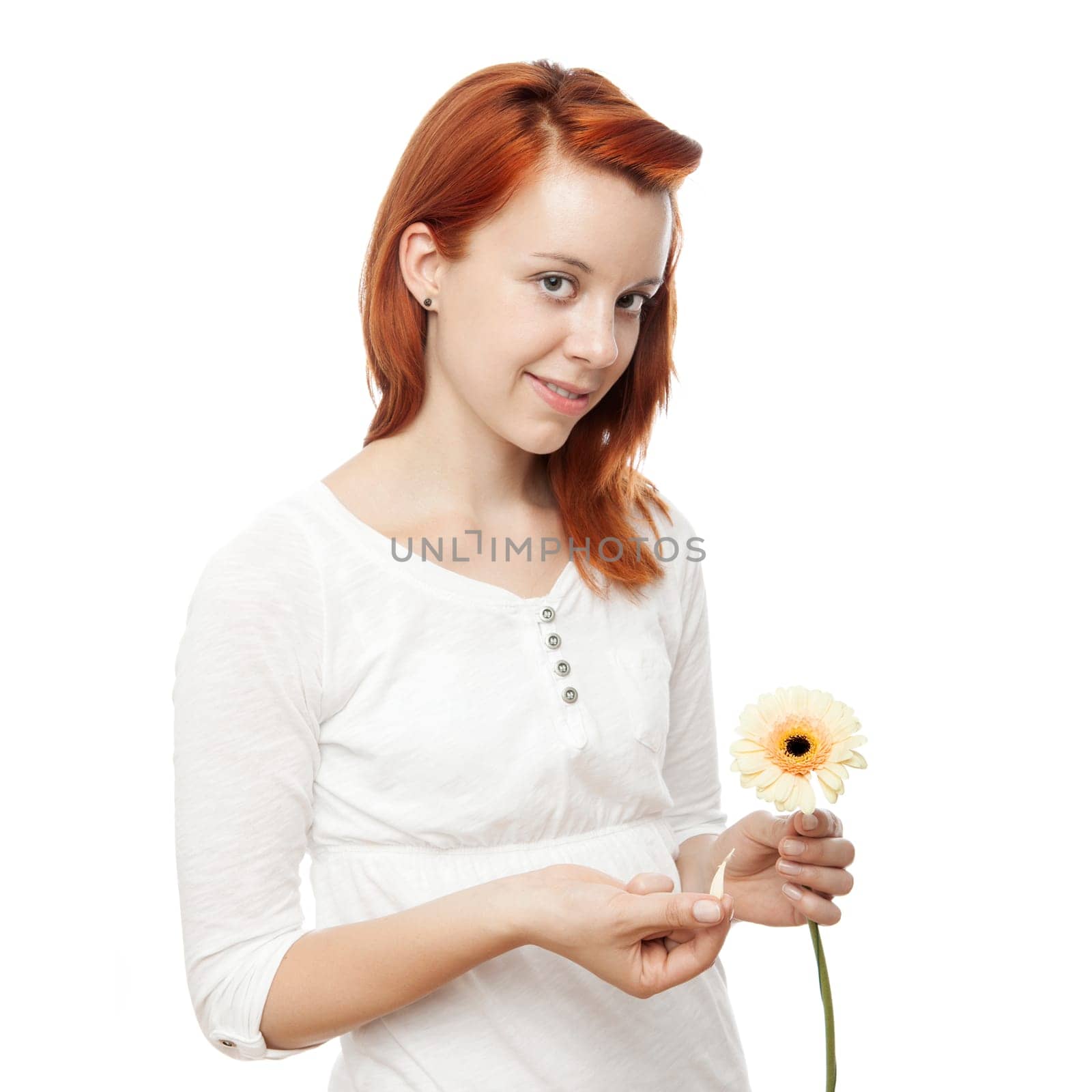 young beautiful red haired girl is playing he loves me in front of white background