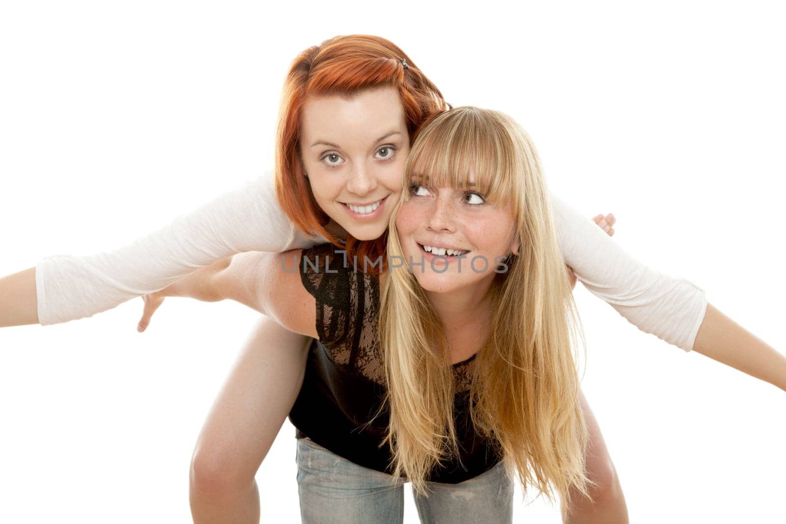 young beautiful red and blond haired girls in front of white background