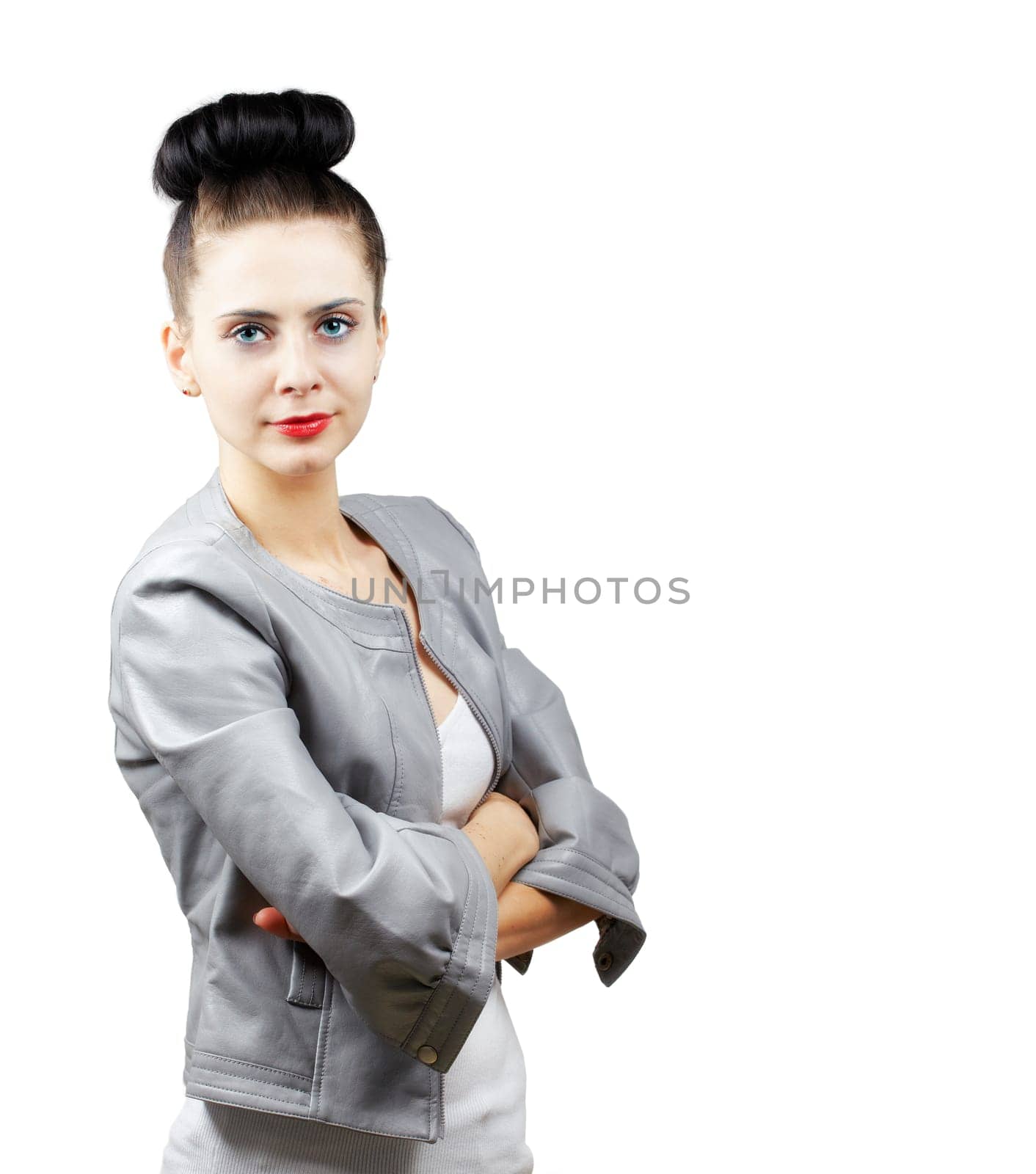 Portrait of a beautiful young woman with grey jacket and arms crossed isolated on white.
