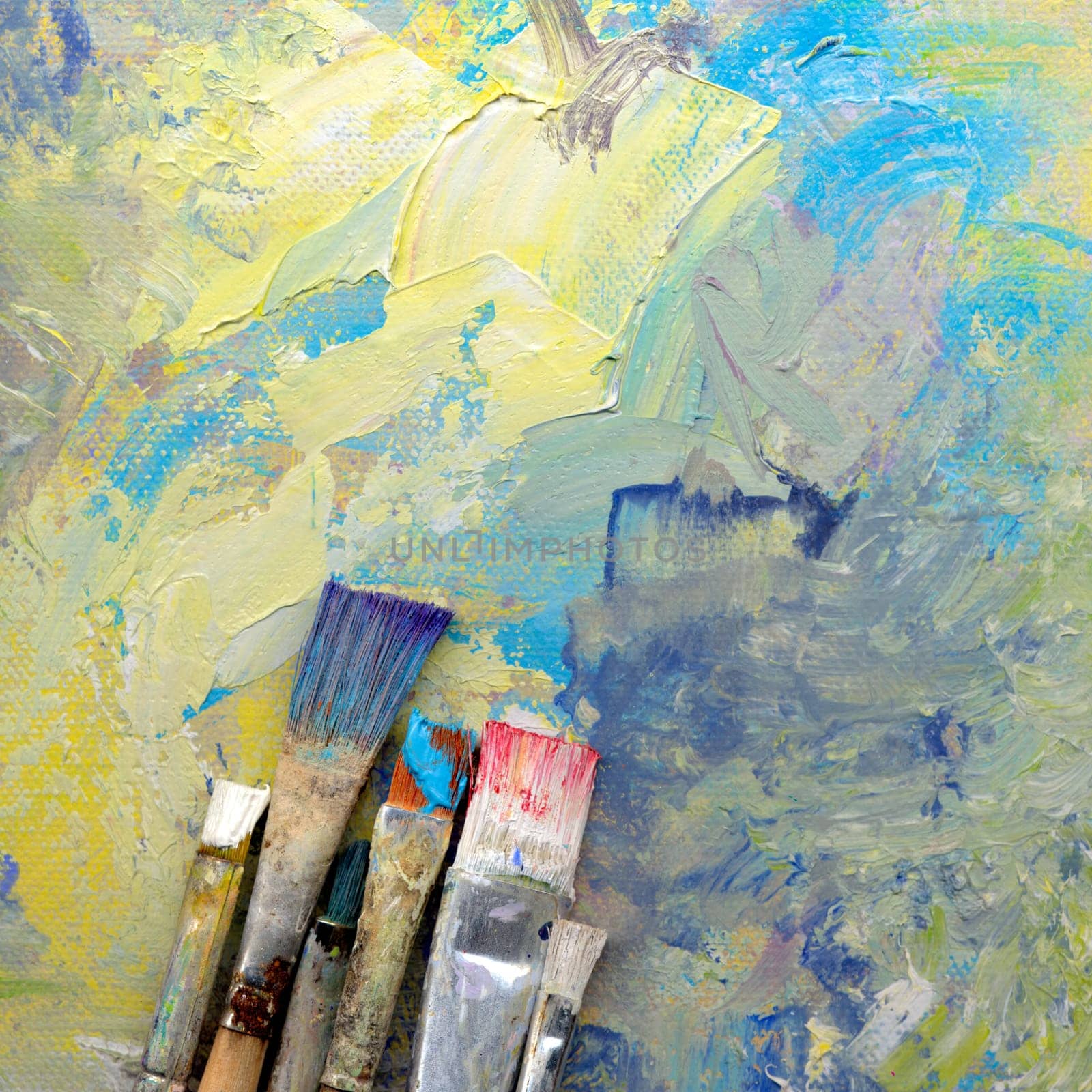 Different brushes with paint on painted background