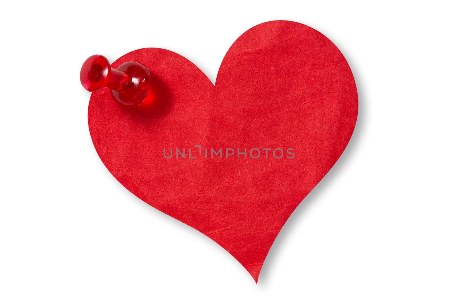 Paper heart pinned with pushpin on the white background