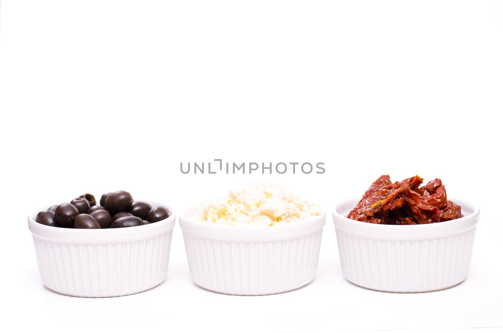 Olives,feta and dried tomatoes on a white background