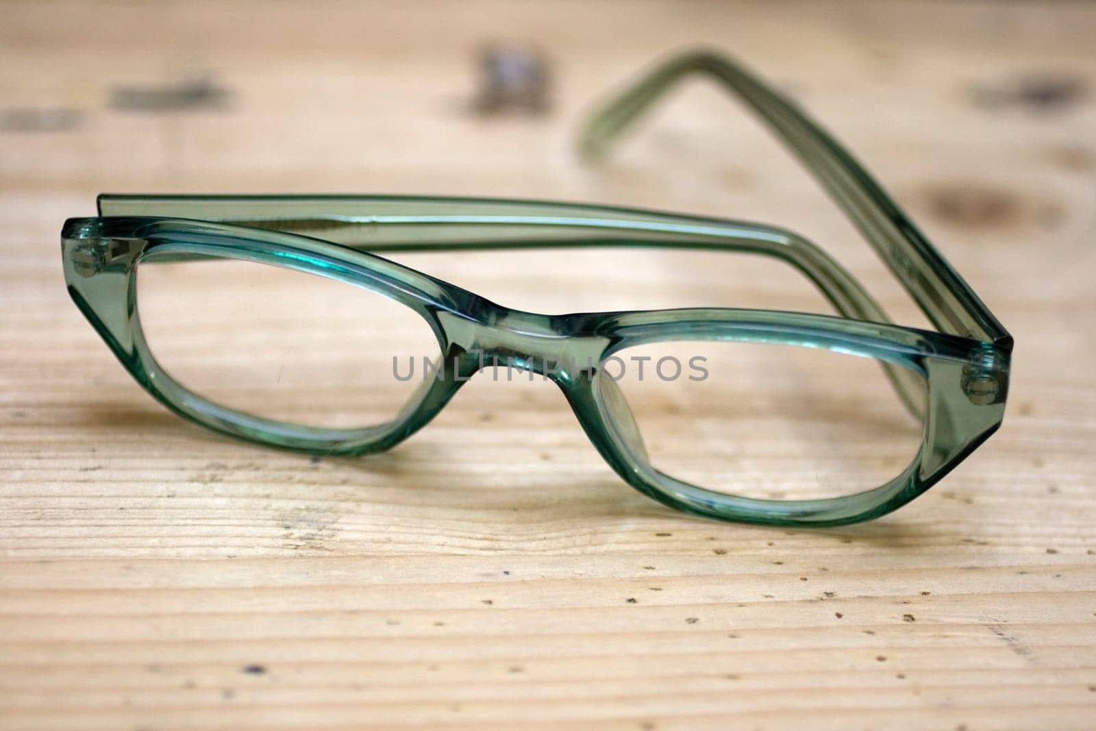 Green glasses on a wooden desk