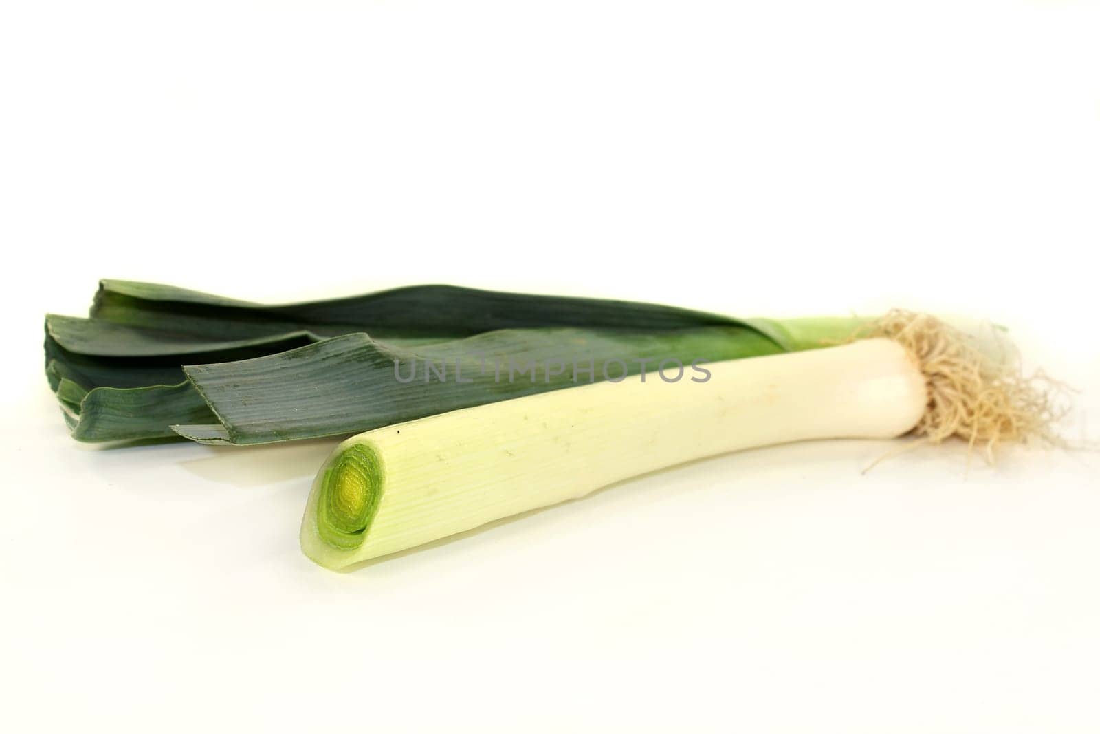 raw leeks against white background
