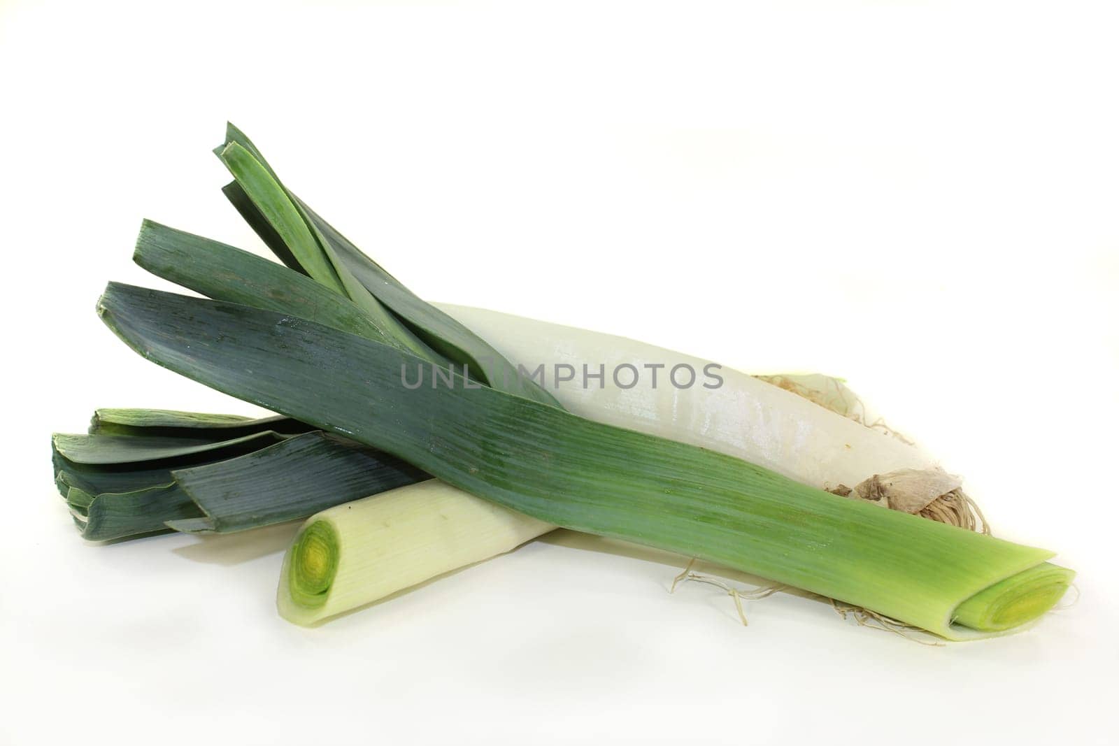 raw leeks against white background