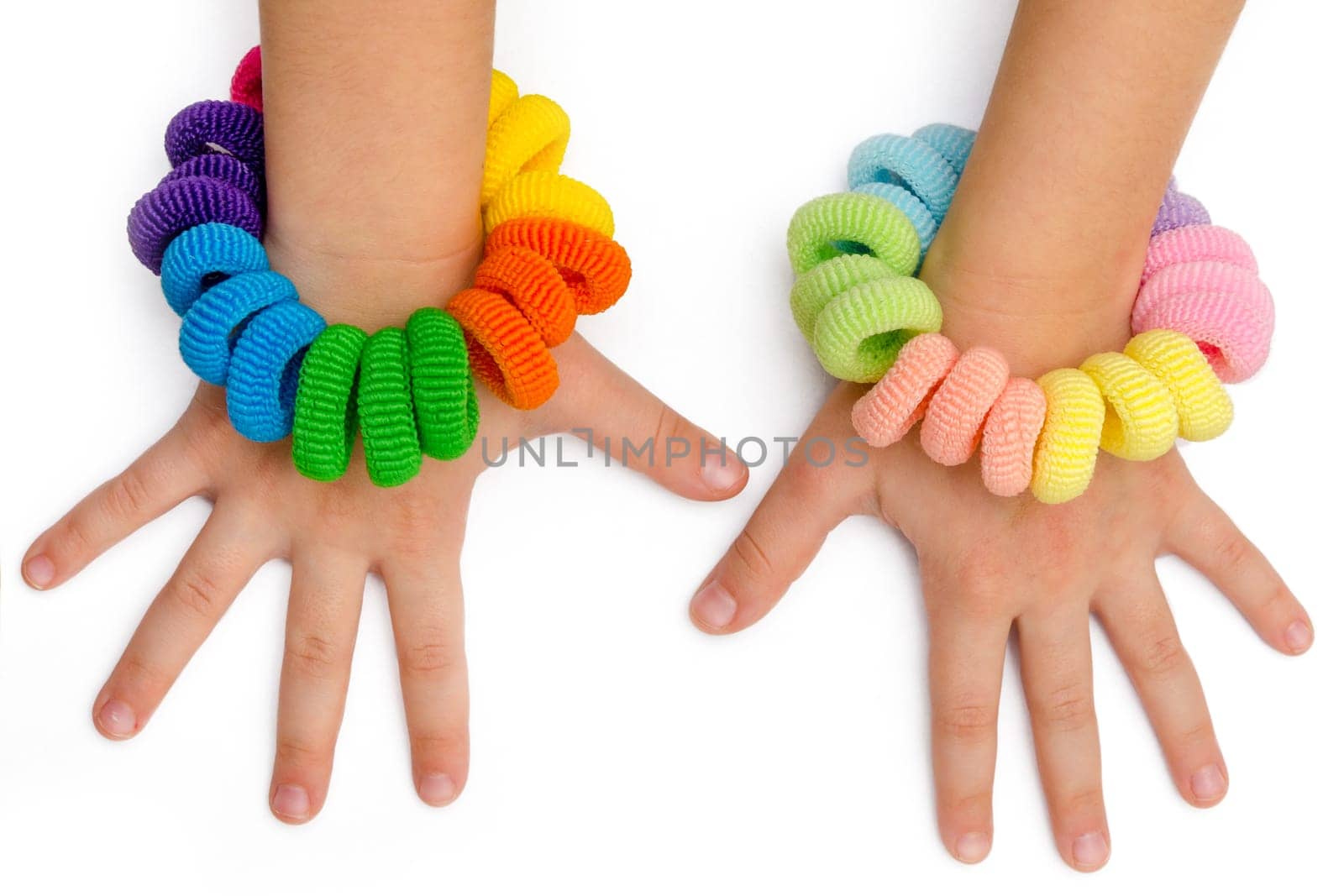 hands of a little girl with hair bands of many colors