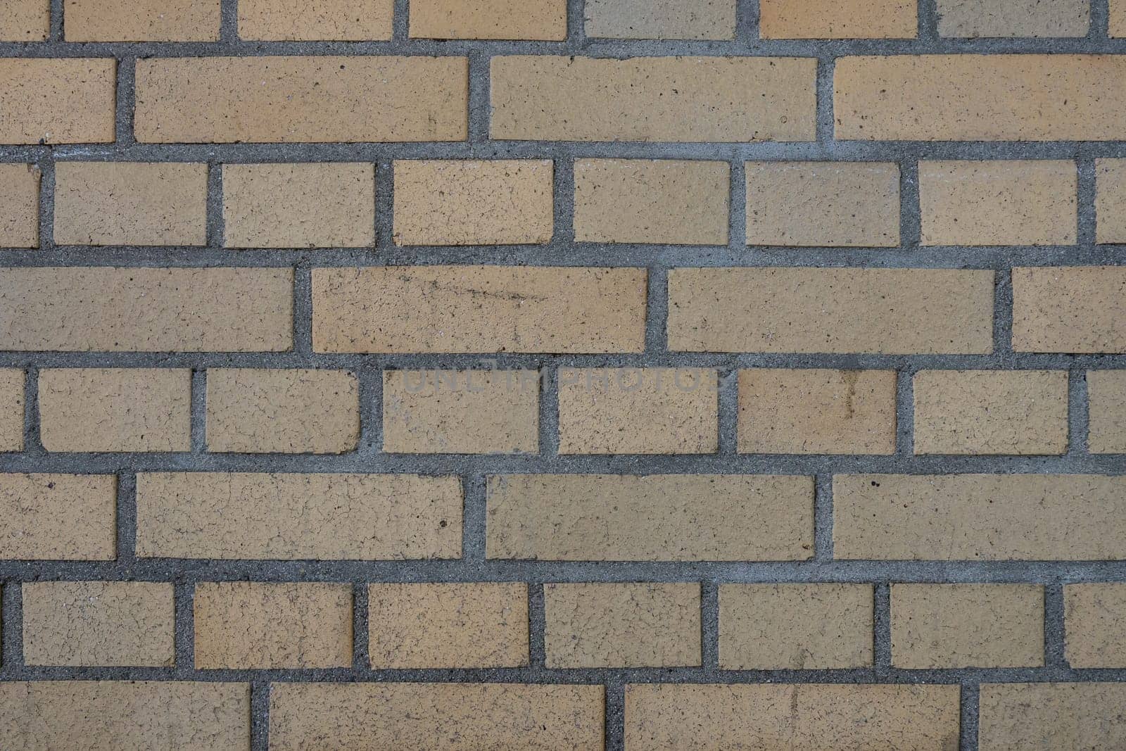 a yellow brickwall from an industry building