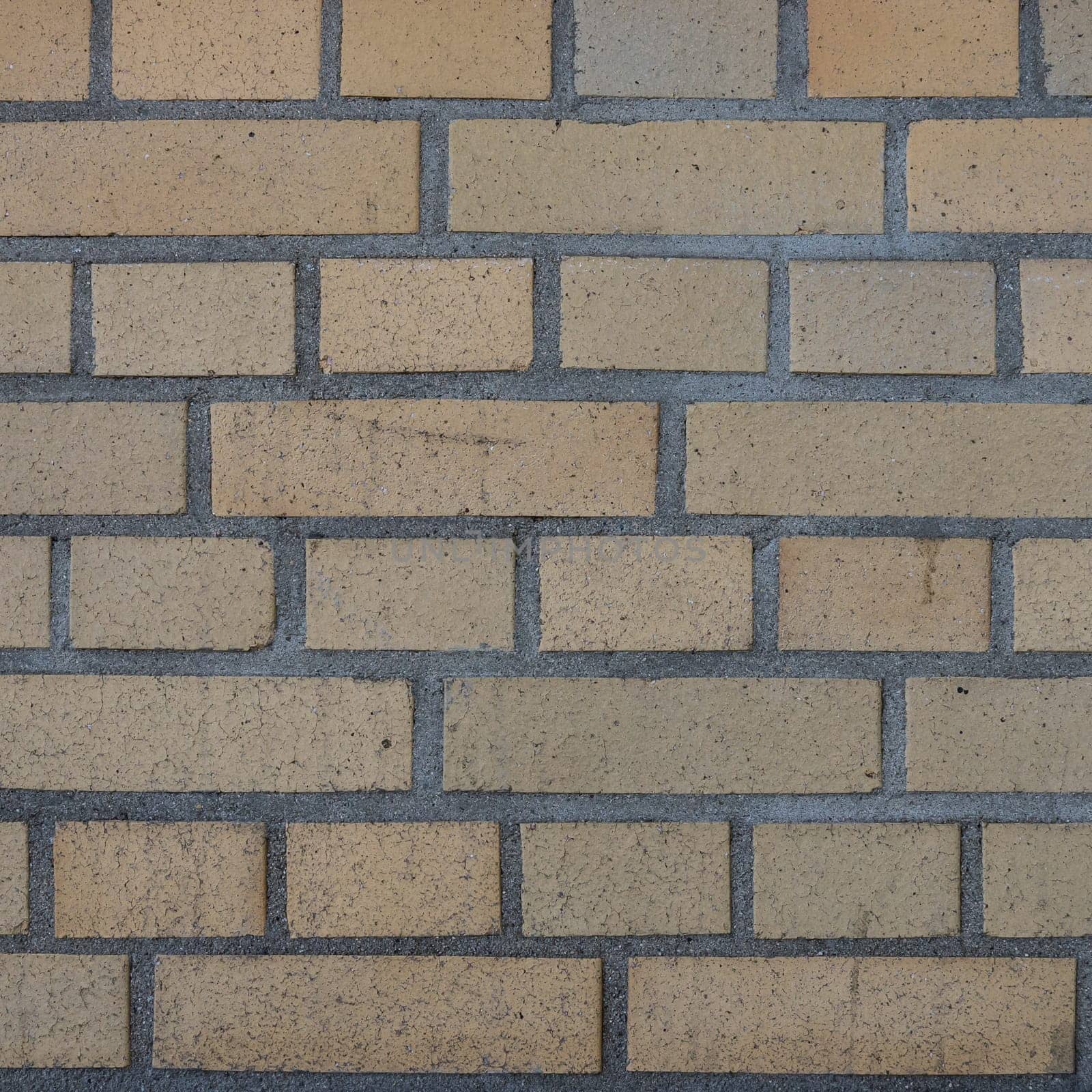 a yellow brickwall from an industry building