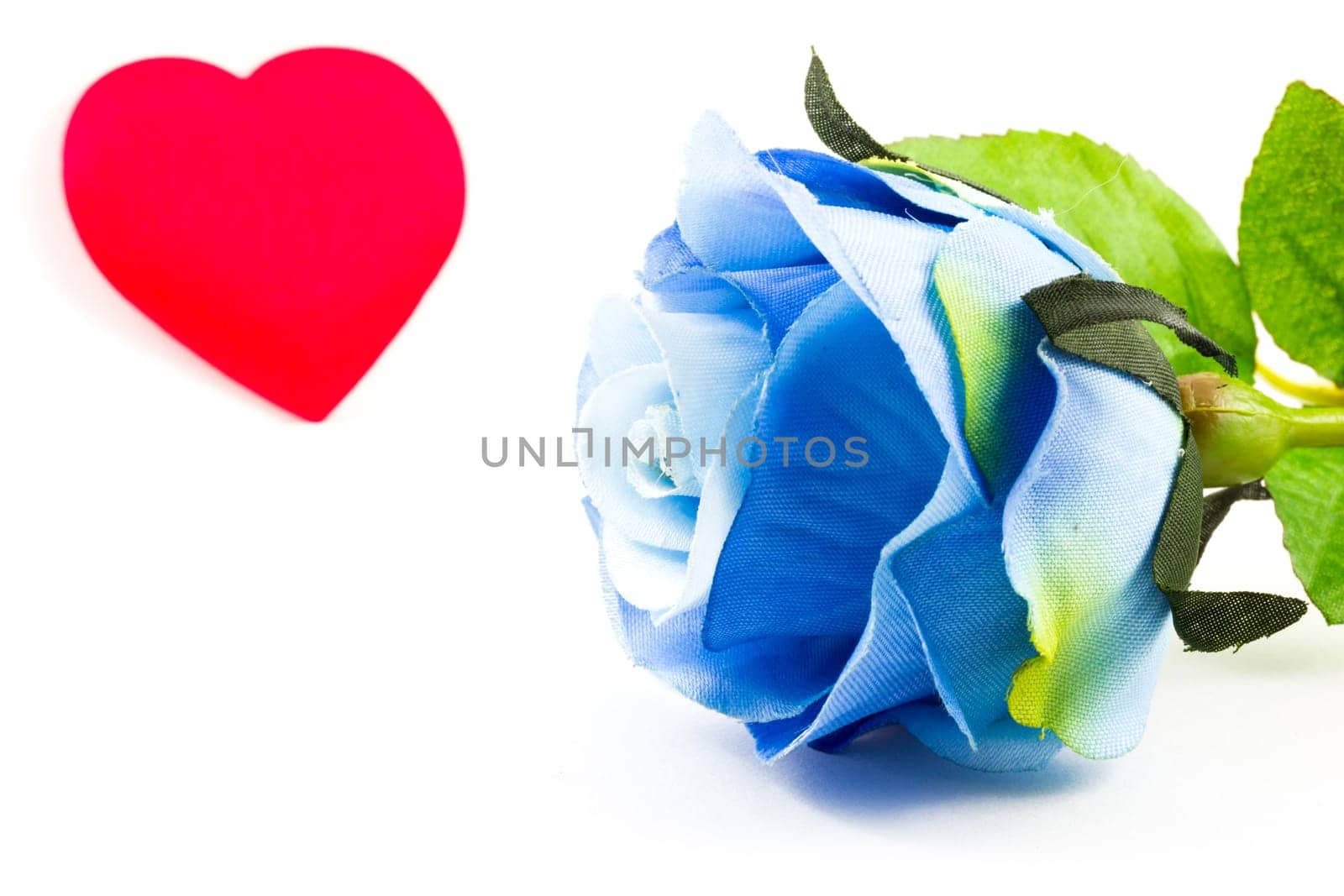 Blue rose and a heart on the background