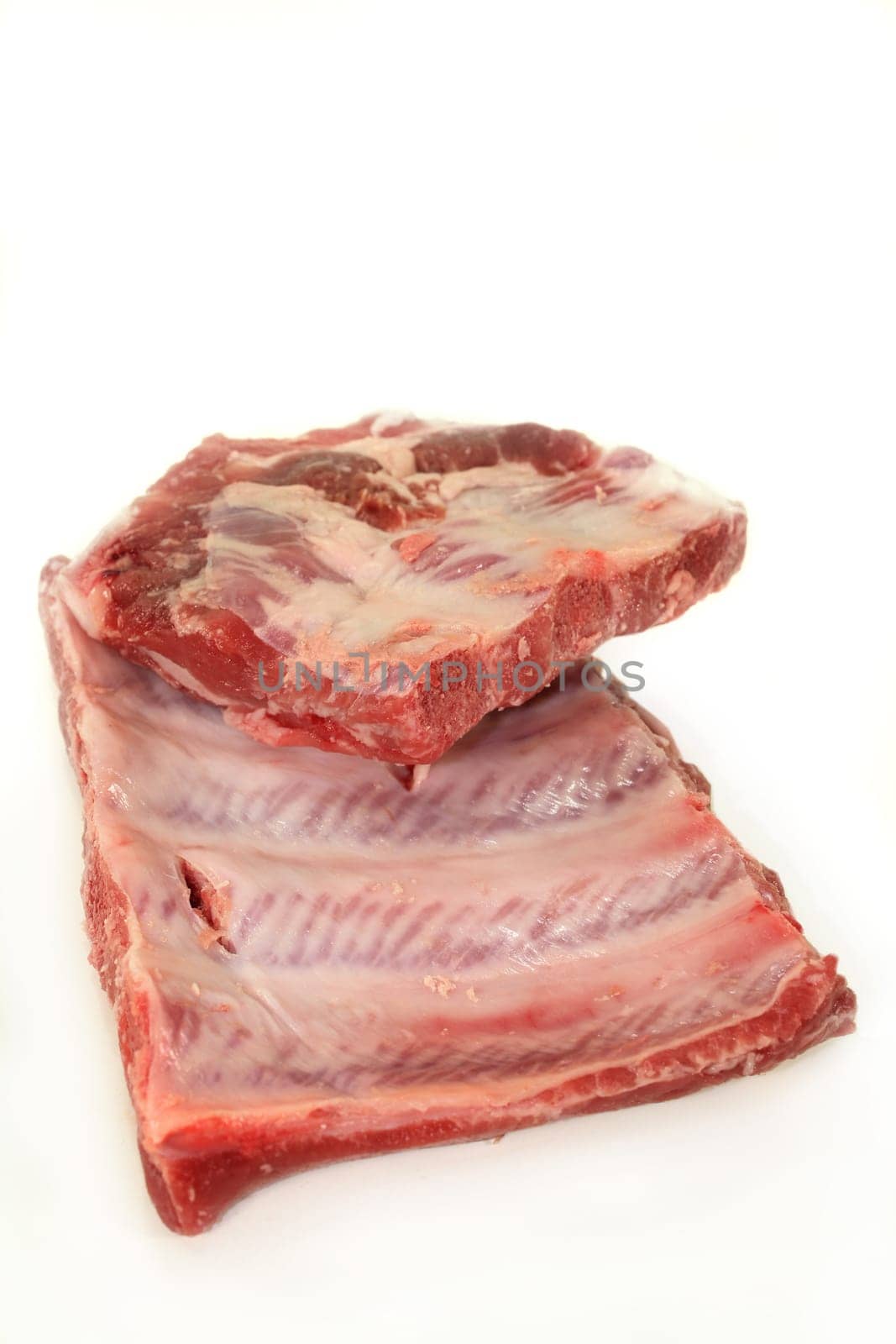 two pieces of peeled ribs against a white background