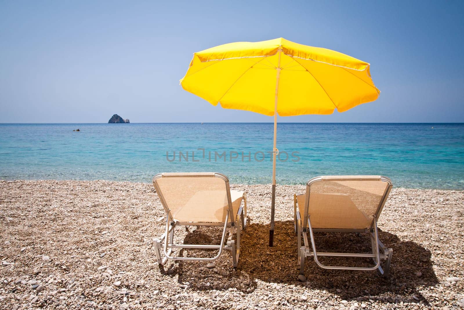 Sun loungers and parasol on the beach