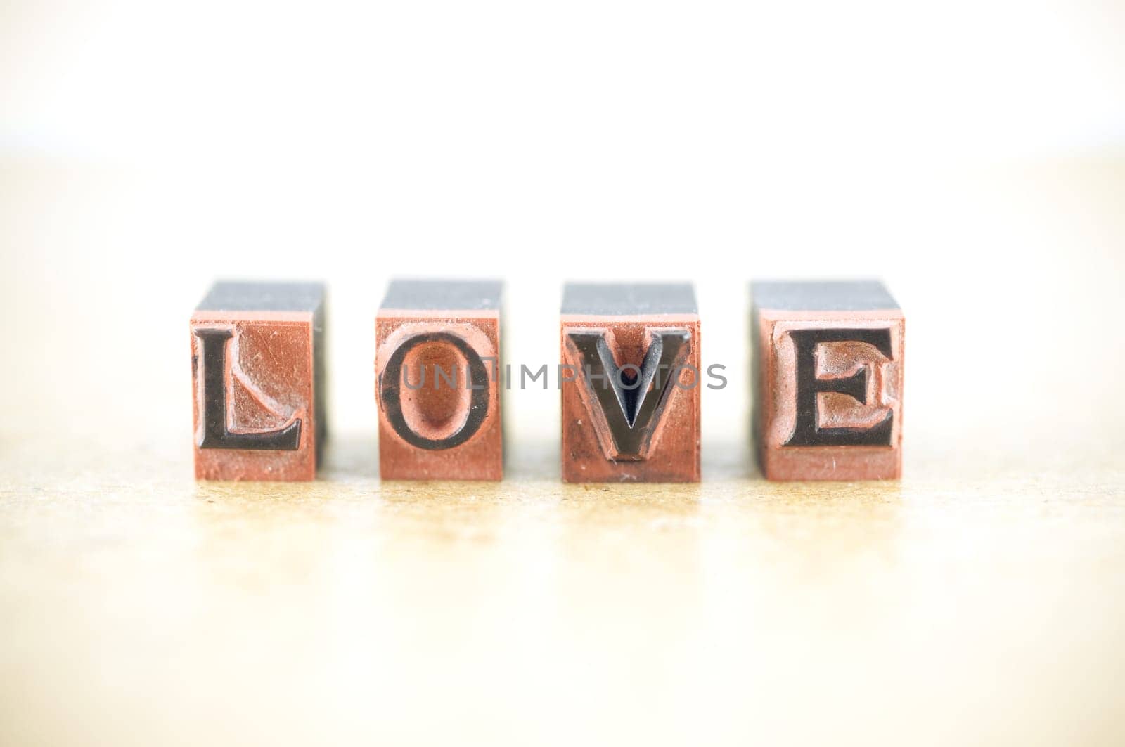 Word "love"" spelled out in letterpress letters."