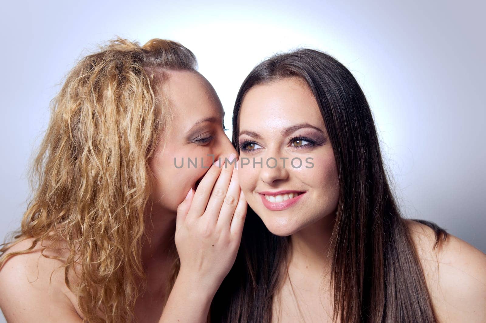 young woman sharing secret to her friend