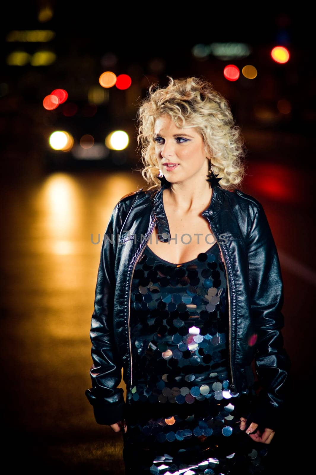 Beautiful young woman in the city at night