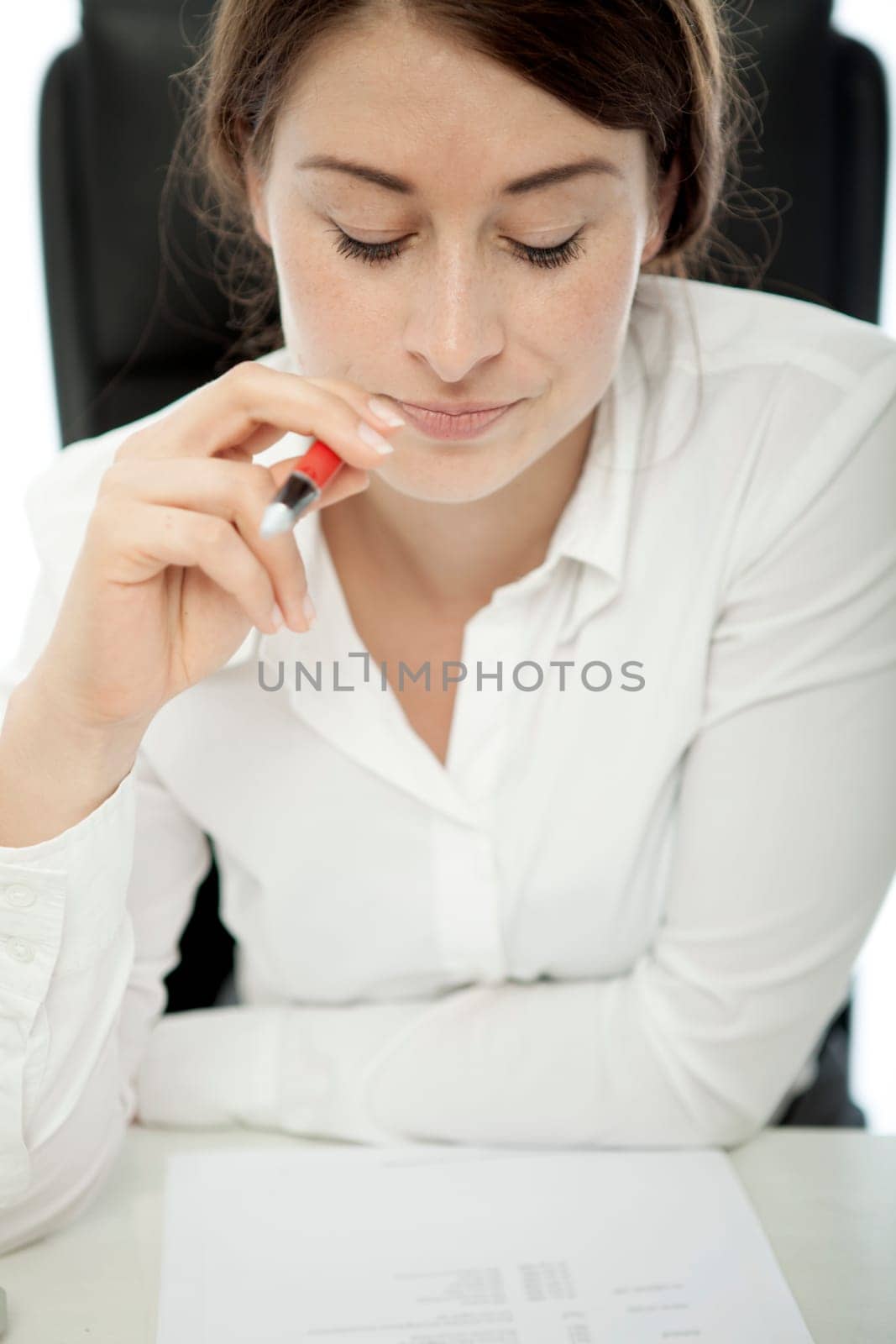 young brunette business woman thinking pen