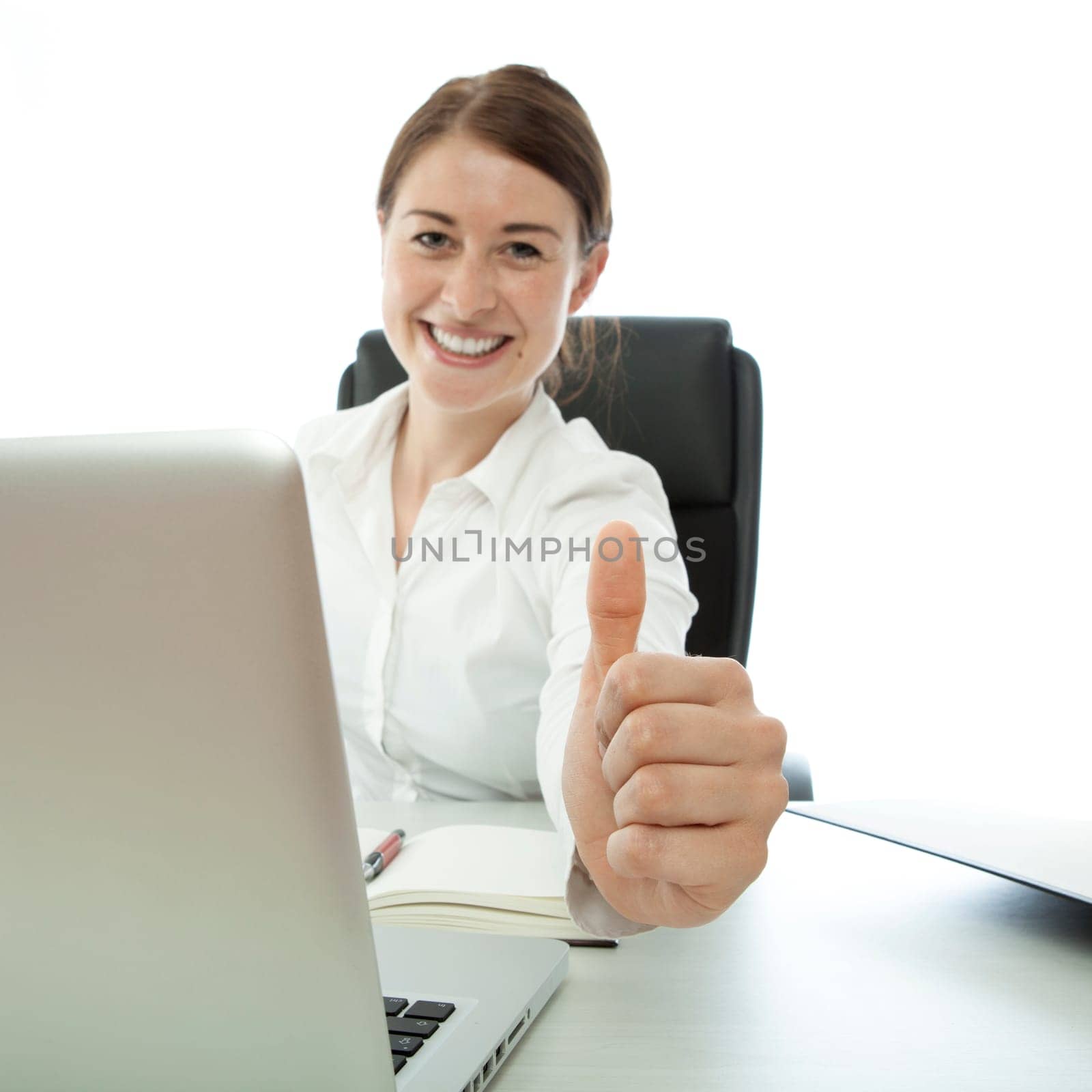young brunette business woman thumb up on desk