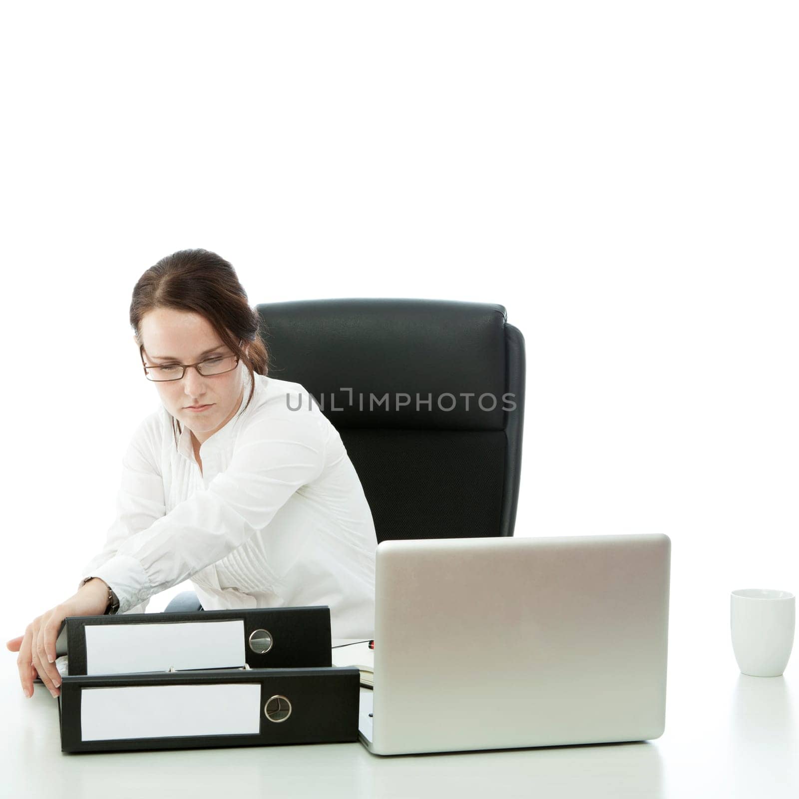 young brunette businesswoman with glasses want to throw lapotp of desk