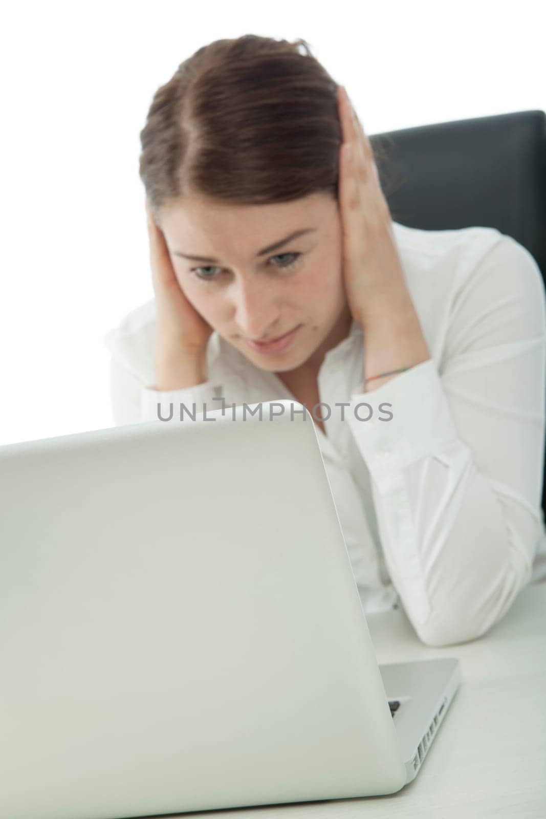 young woman her covering ears in front of laptop