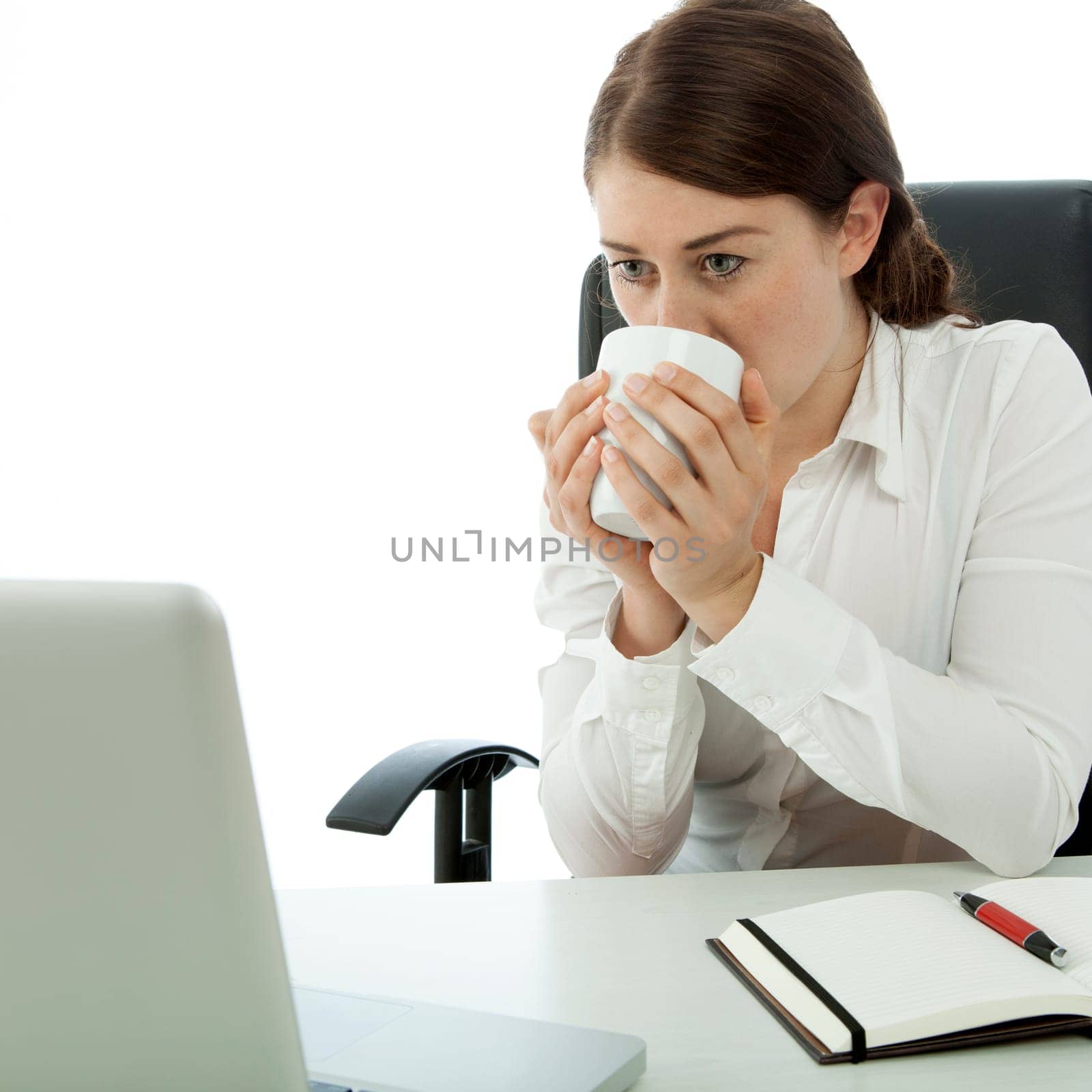 young brunette business woman drink coffee in front of computer