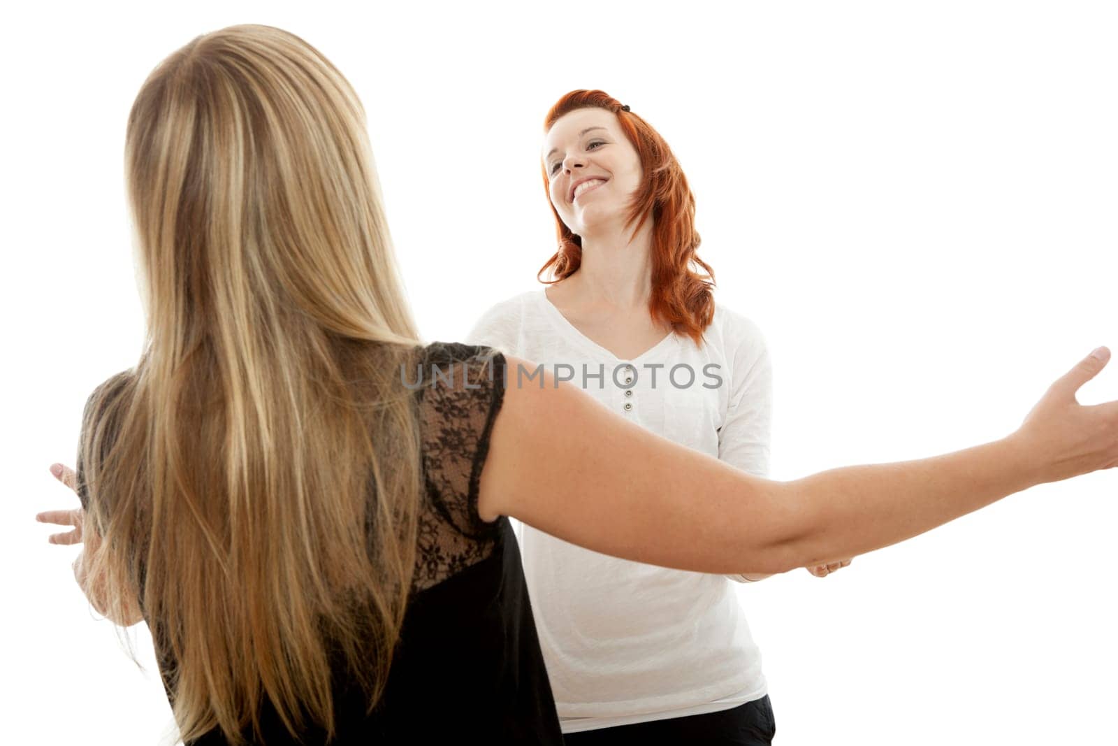 young beautiful red and blond haired girls in front of white background
