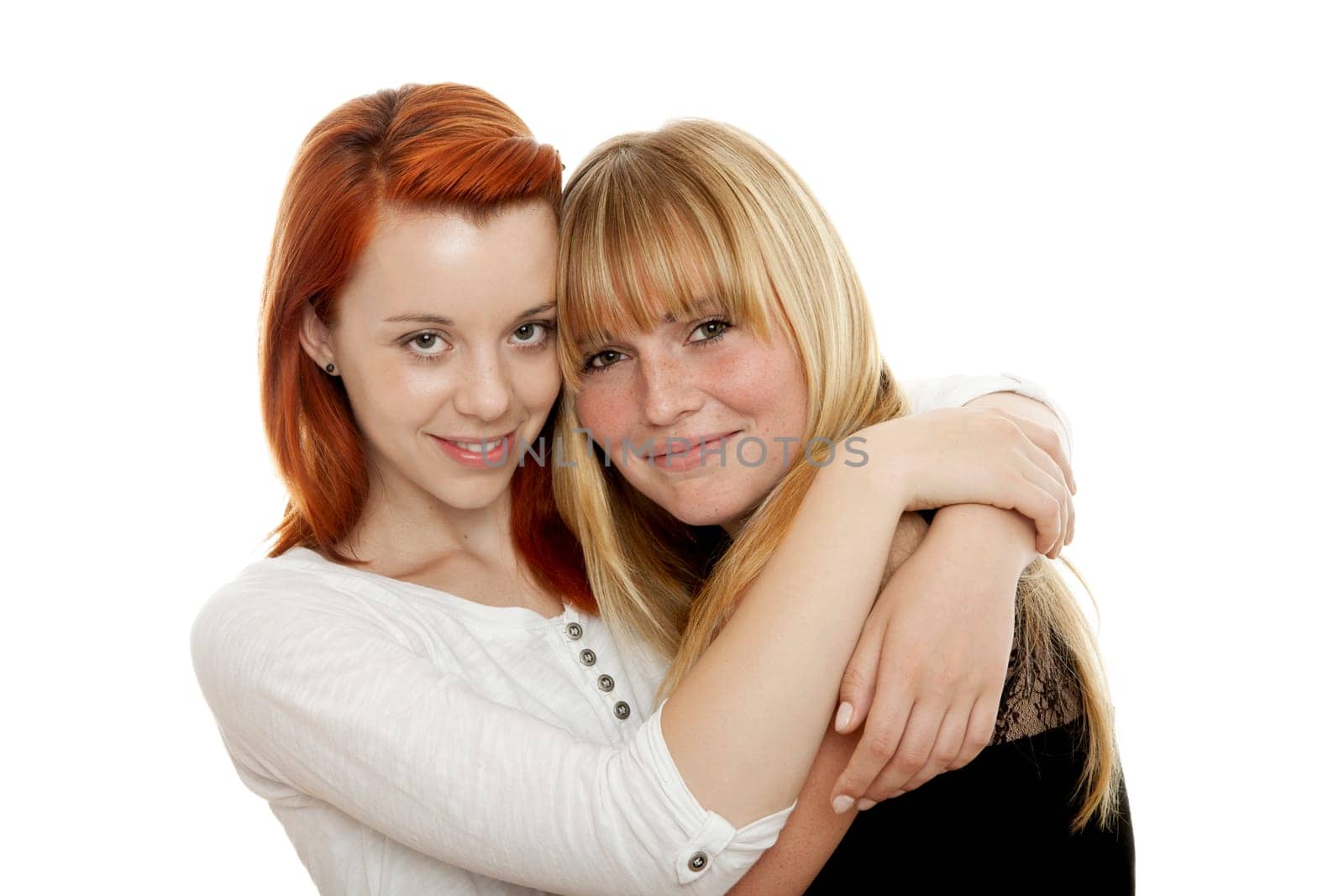 young beautiful red and blond haired girls in front of white background