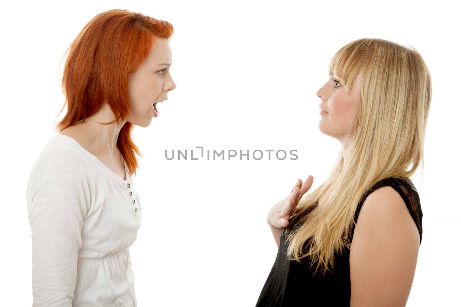 young beautiful red and blond haired girls in front of white background