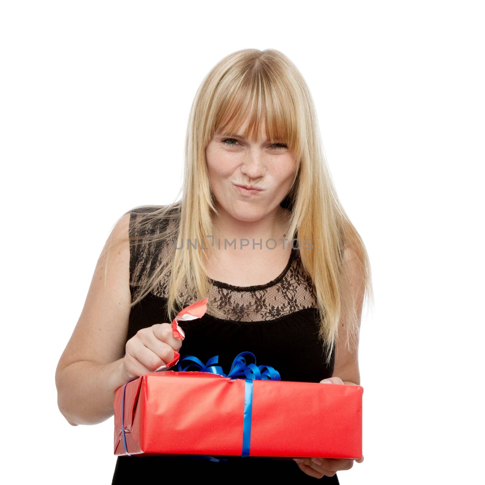 young beautiful blond haired girl open gift in front of white background
