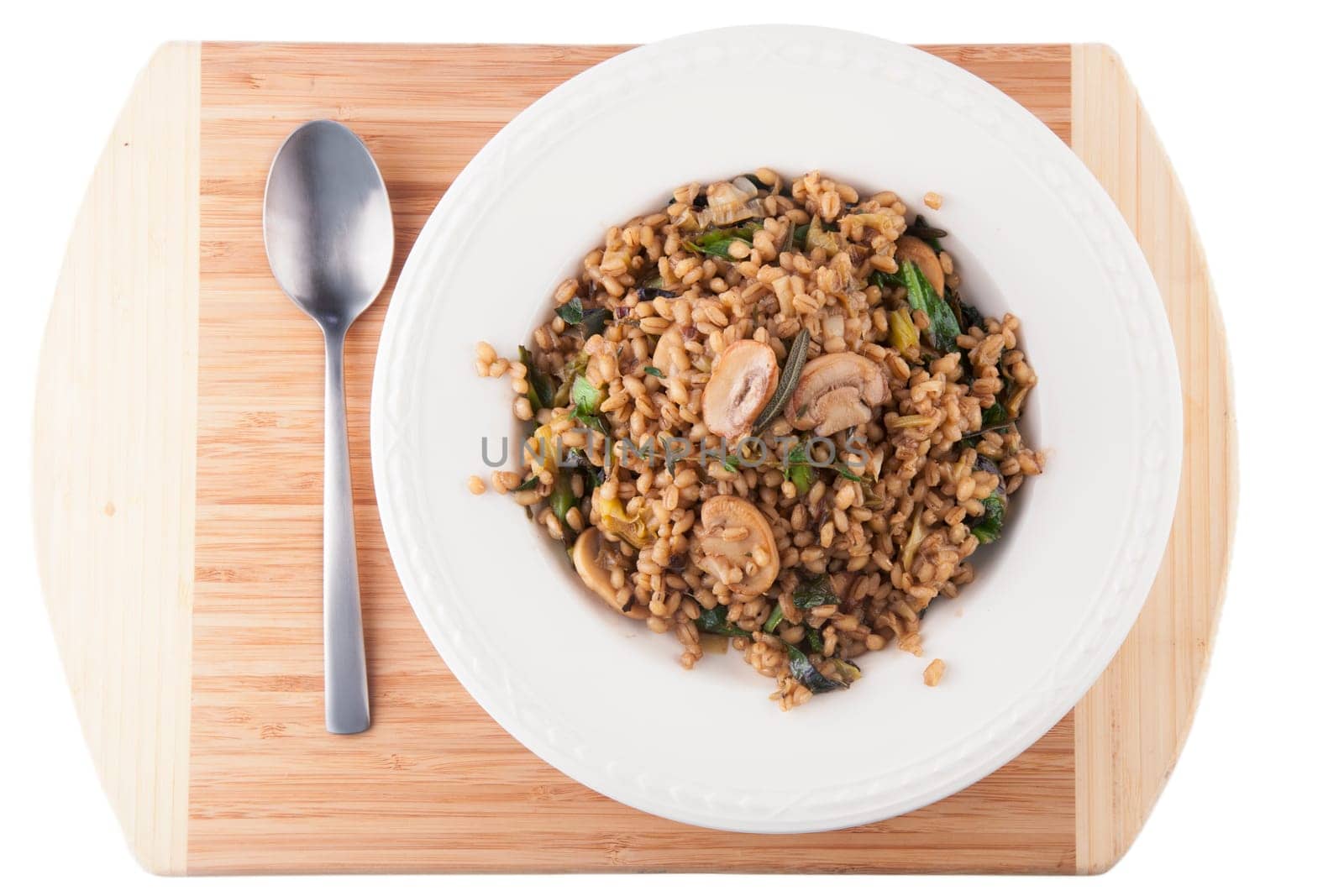Healthy vegan barley dish with mushrooms collard greens, thyme and rosemary.