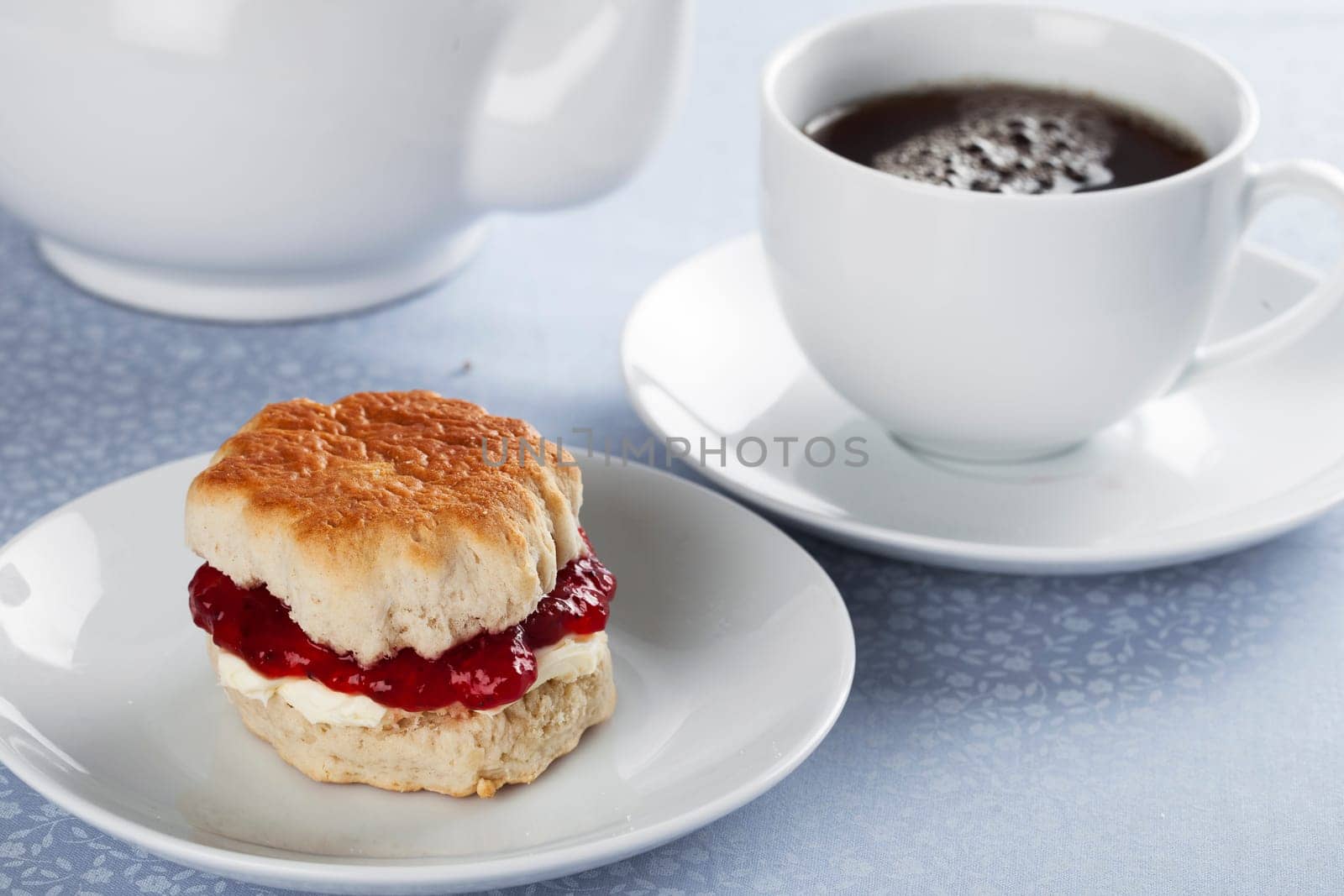 English scones with cream and strawberry jam with tea