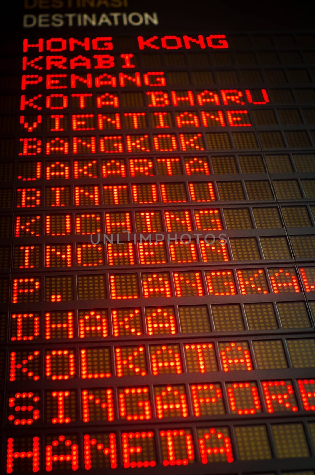 airport departures board that shows asian destinations.