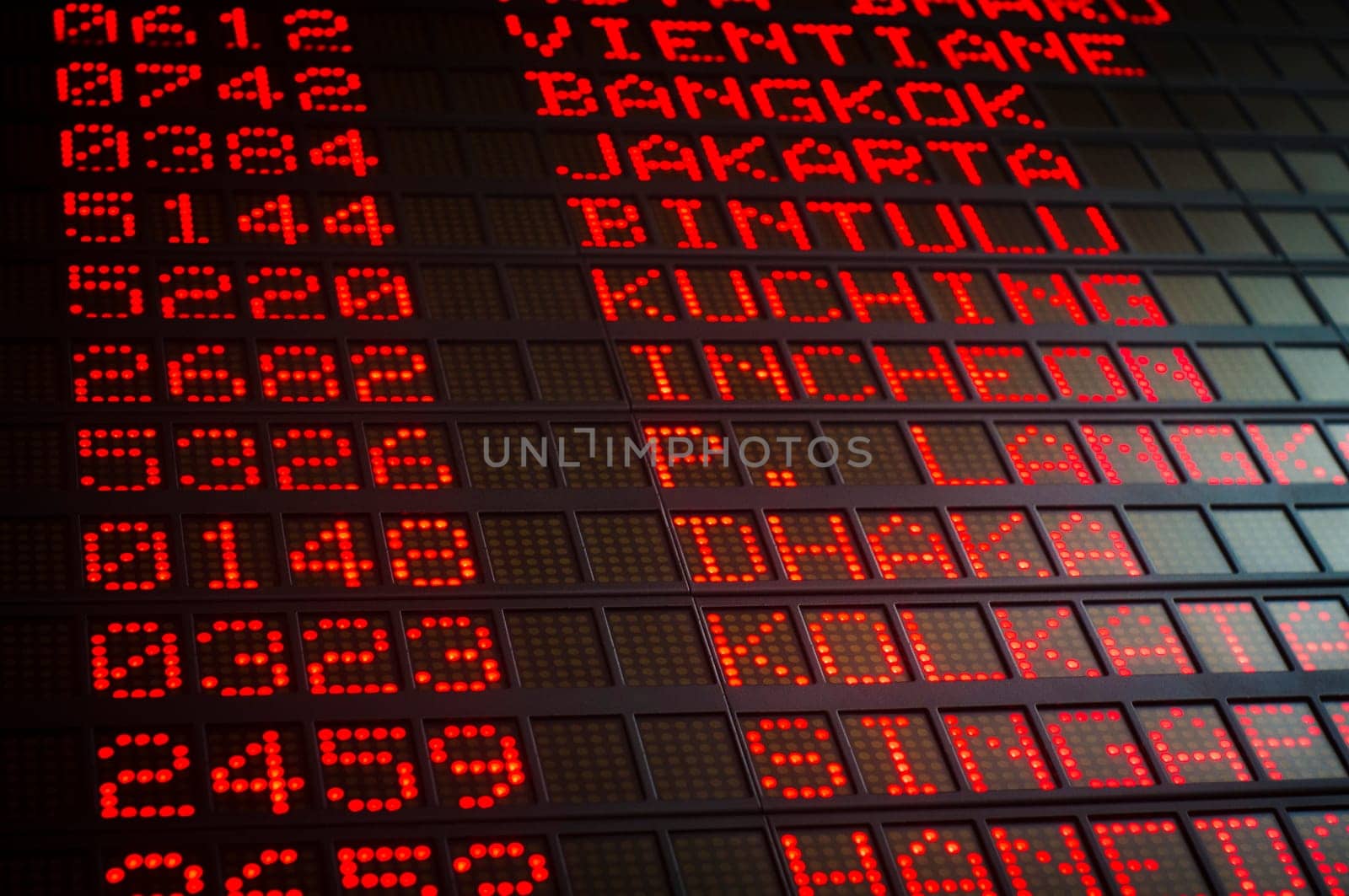 airport departures board that shows asian destinations.
