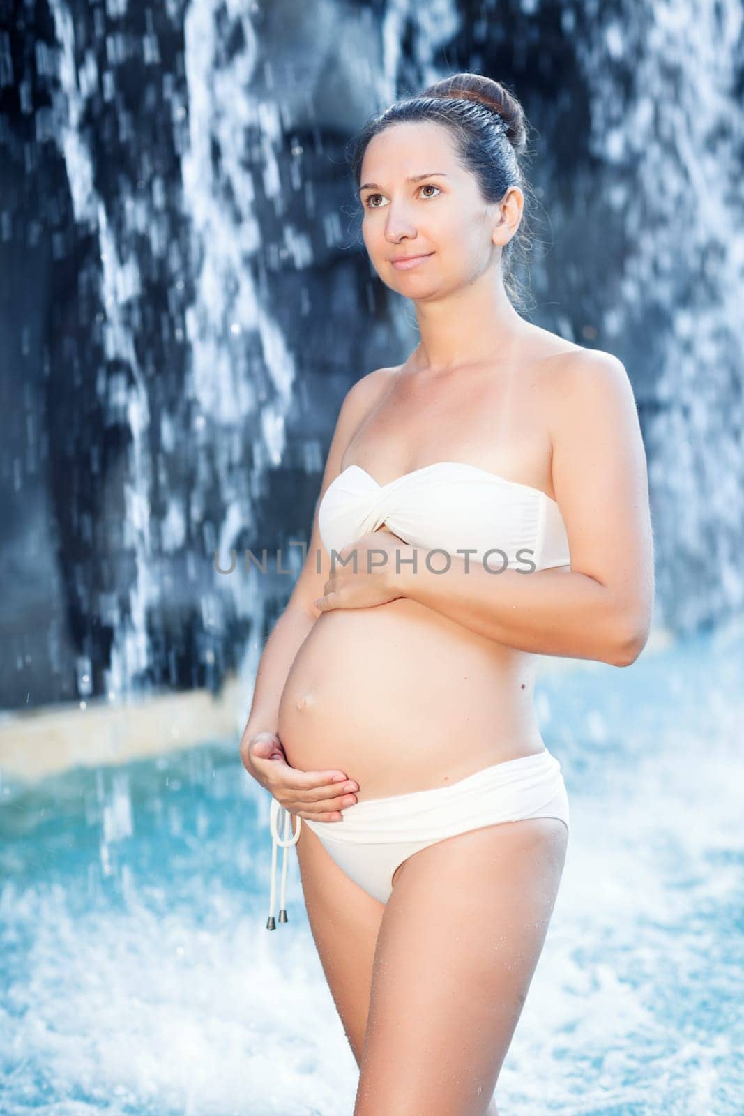 Beautiful pregnant woman in swimming pool