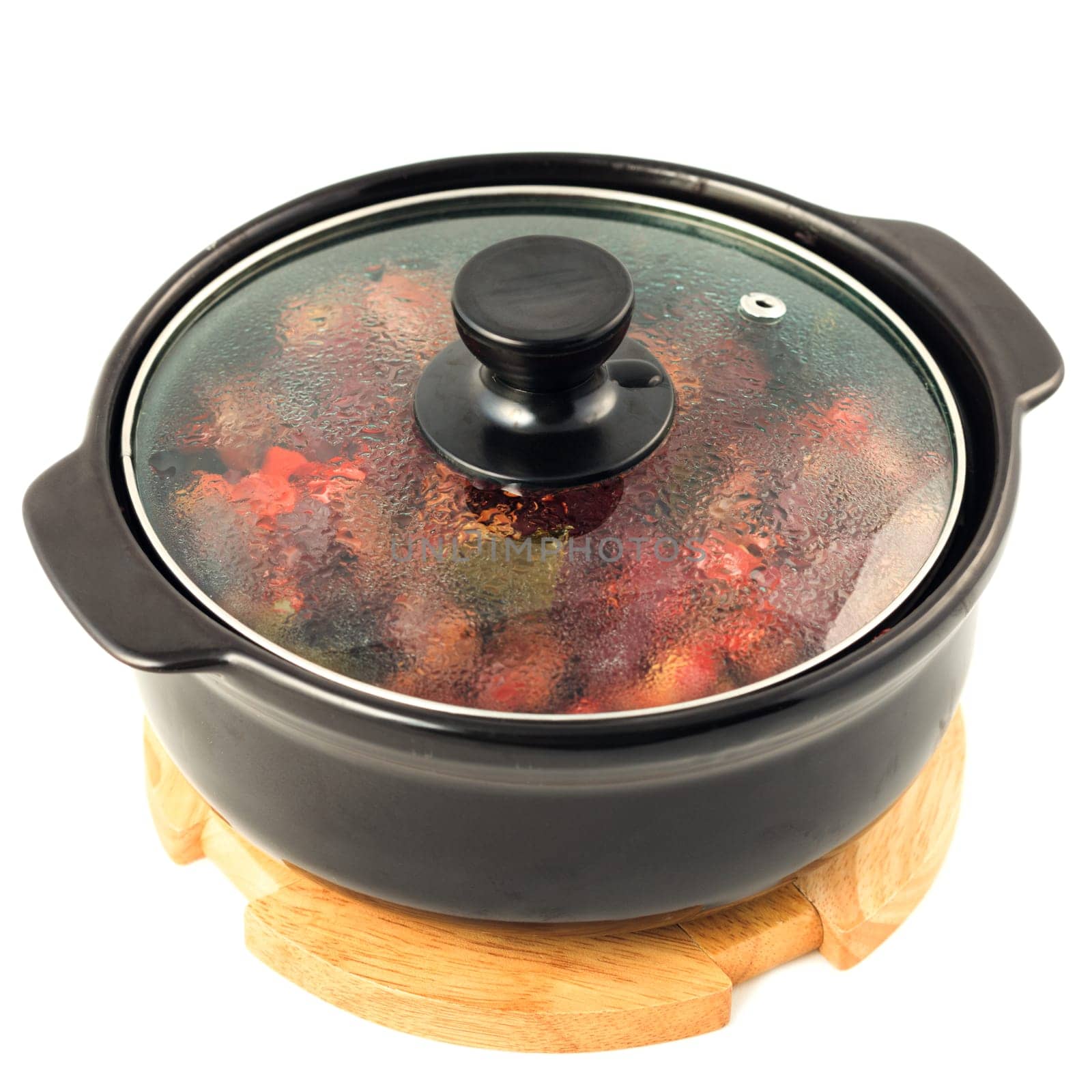 Beef and vegetables stewed in hot pot on white background