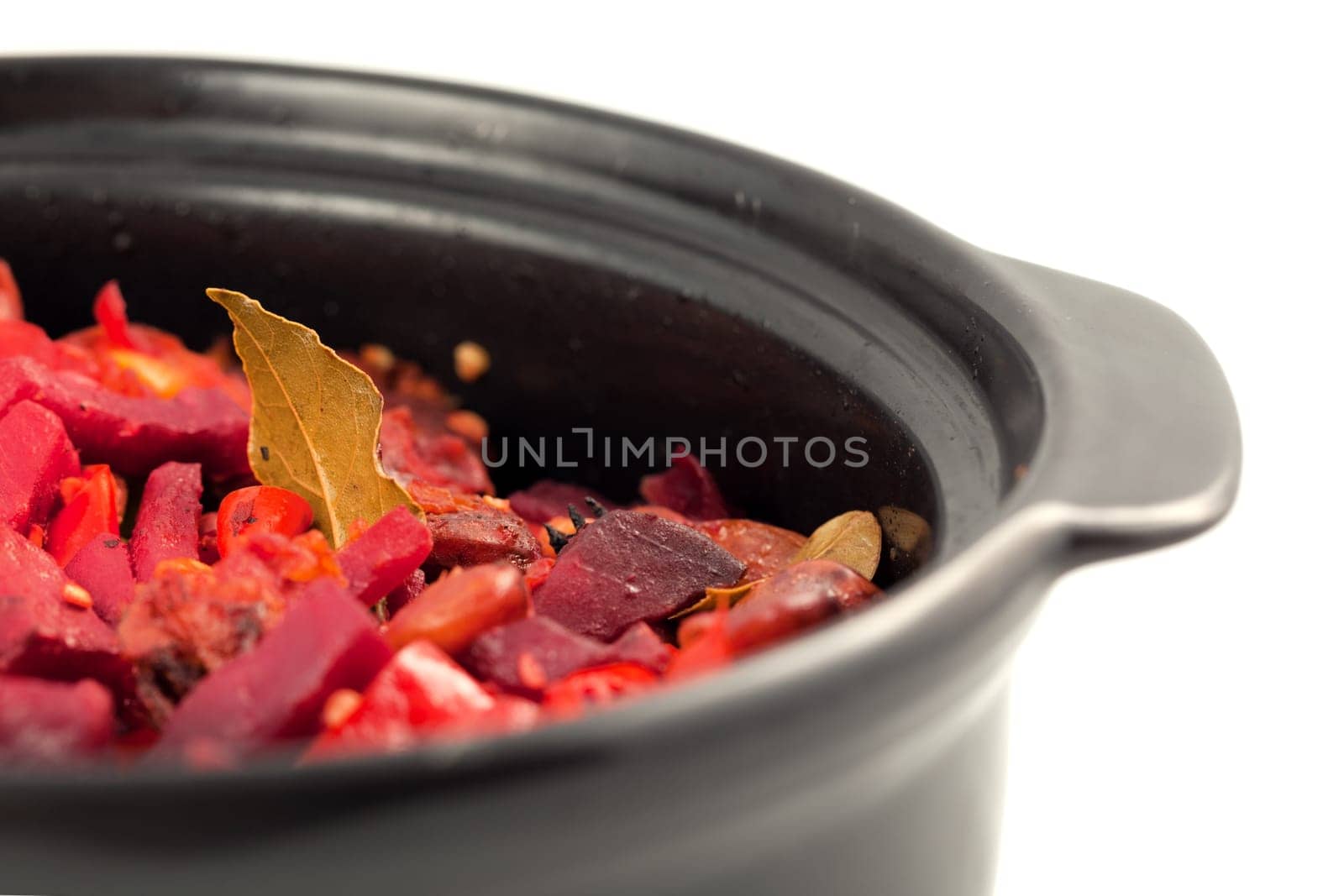 Beef and vegetables stewed in hot pot on white background