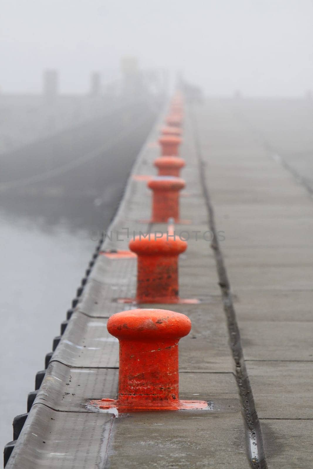 Row of bollards in the fog on Heligoland