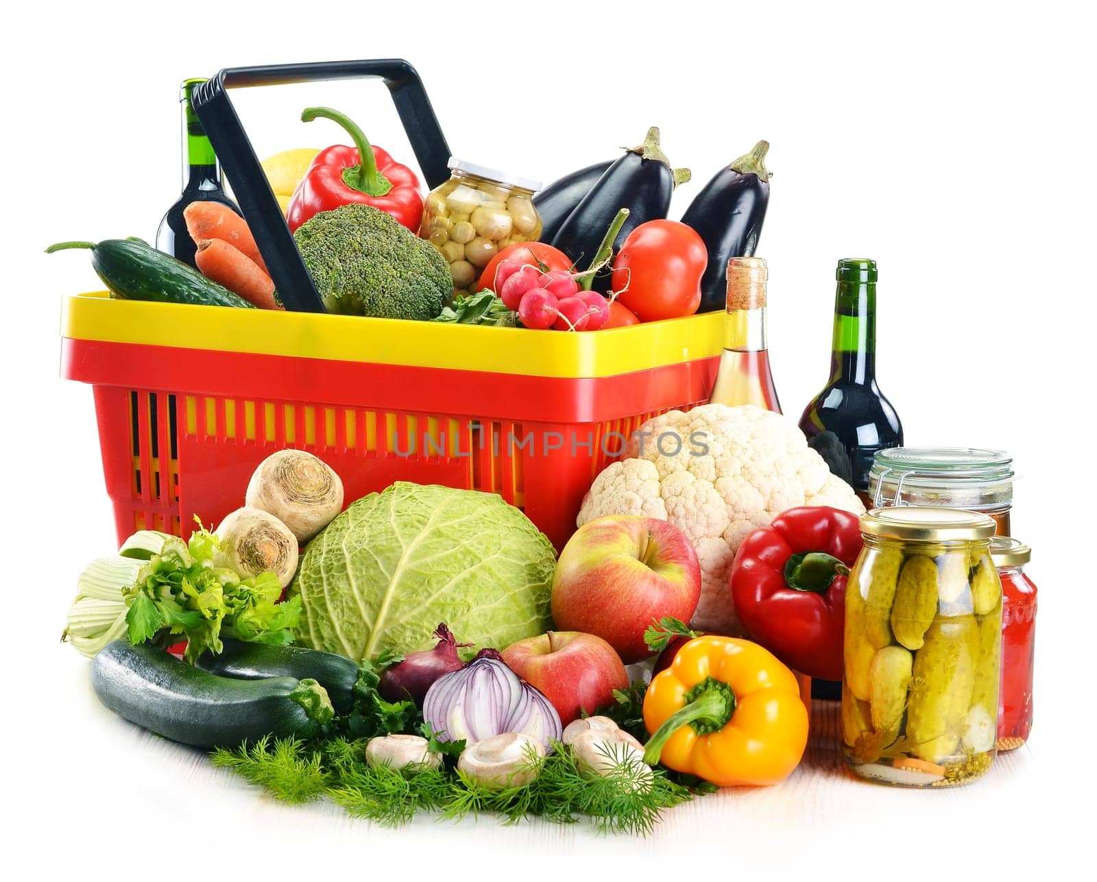 Composition with plastic shopping basket and grocery isolated on white