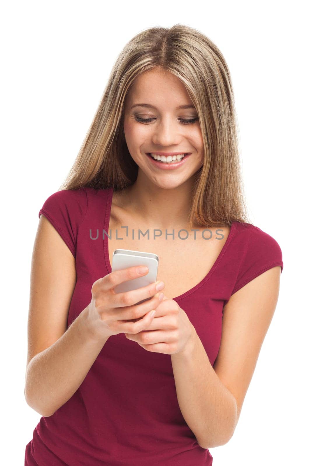 Girl writing or receiving a message on her phone, on white